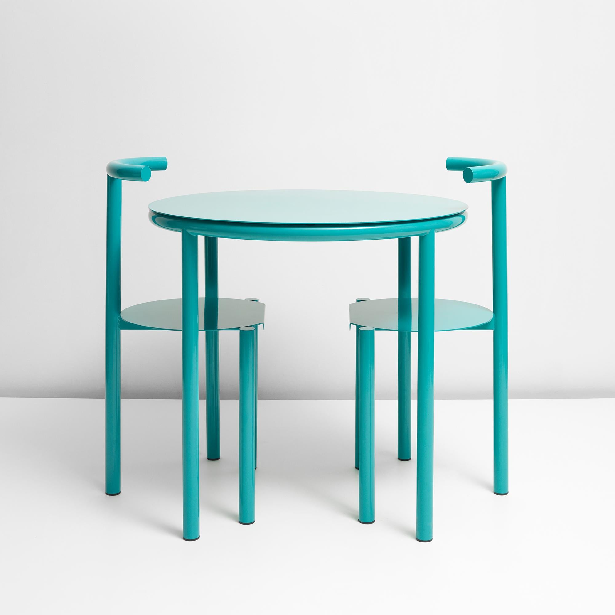 A cafe table sold here with 2 of its partner the B Series chair.

The B - Series takes the graphical shapes found in the urban environment and reimagines them in to a bold statement pieces. With both post-modernist and modernist influences that