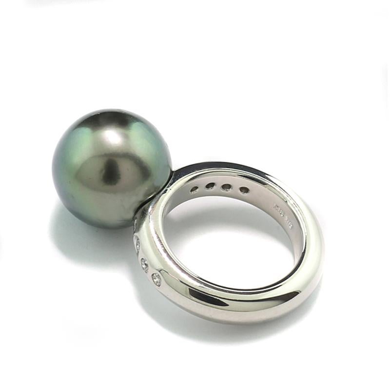 Ring with a huge Tahitian pearl of 13 mm diameter, round shape, natural gray with shimmering overtones of silver, peacock green and rosé, fine luster, smooth surface with slight pearl typical growth features.  8 natural brilliant cut diamonds total