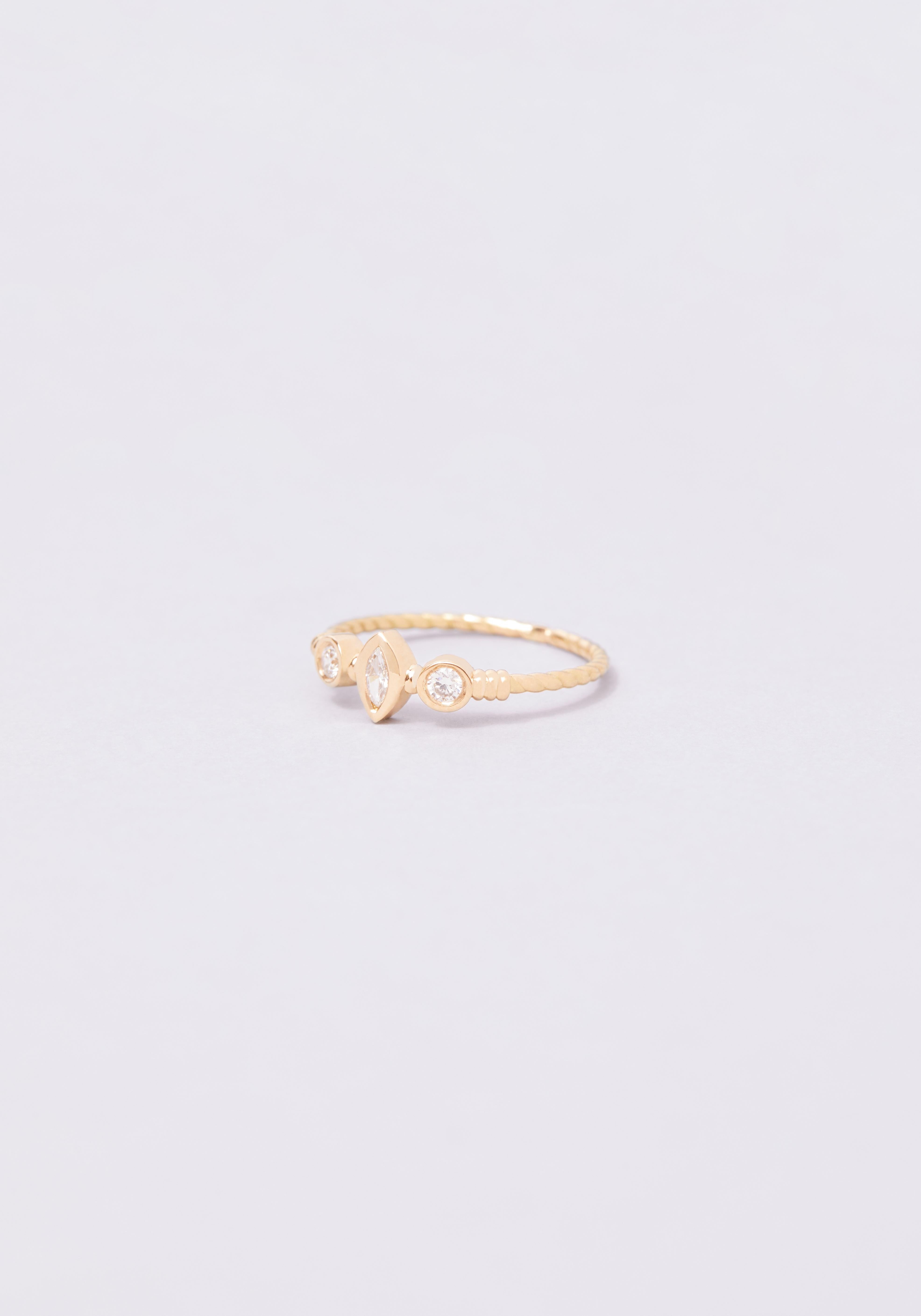 The Théa ring: a fusion of oval and round. This twisted ring is set with three white diamonds and presents a harmony of shapes in its utmost simplicity. It would make for the perfect engagement ring and is available in 18k yellow gold. The Théa ring