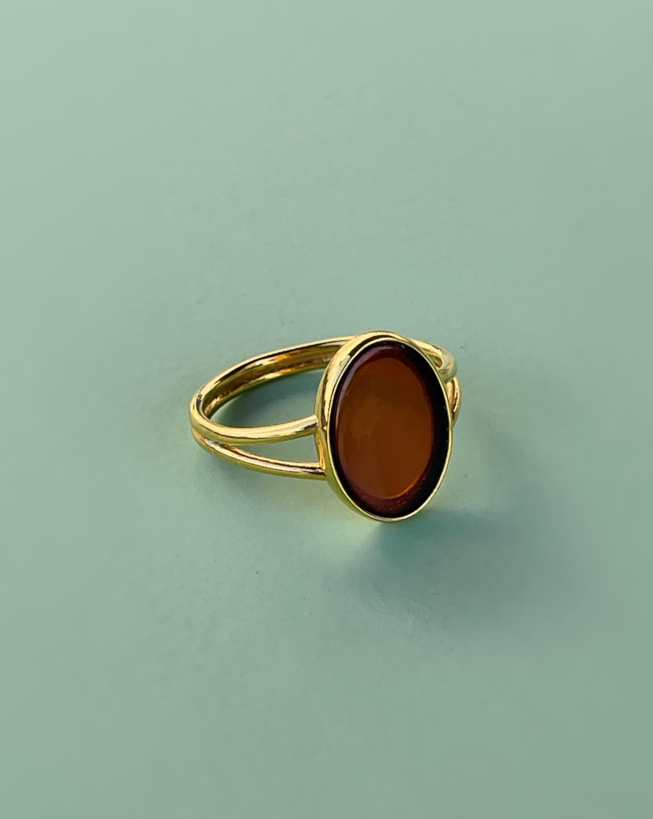 Baltic amber is a stone of happiness and creativity. It's a reminder of warm summer days and a refreshing sea breeze. Put this ring on and enjoy its sunny beauty. 
The ring is made of brass, plated with 24-carat gold. 
Size of the amber: 14mm length