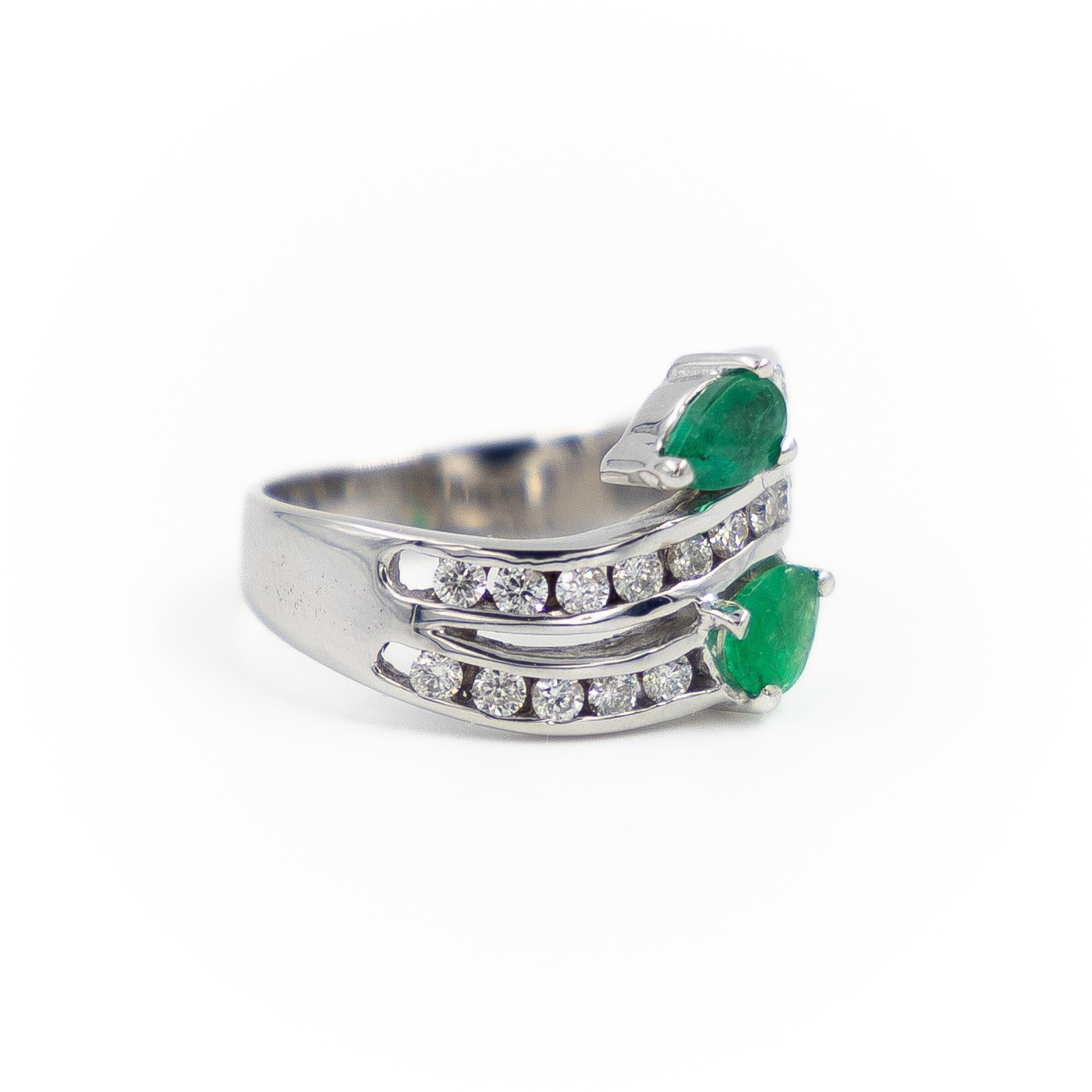 Ring you & me in white gold 750 thousandths (18 carats). set with 2 pear-cut emeralds one approximatively 0.22 ct and the other around 0.20 ct. paving of 21 diamonds brilliant size of approximately 0.01 ct each one. total weight of diamonds: 0.21