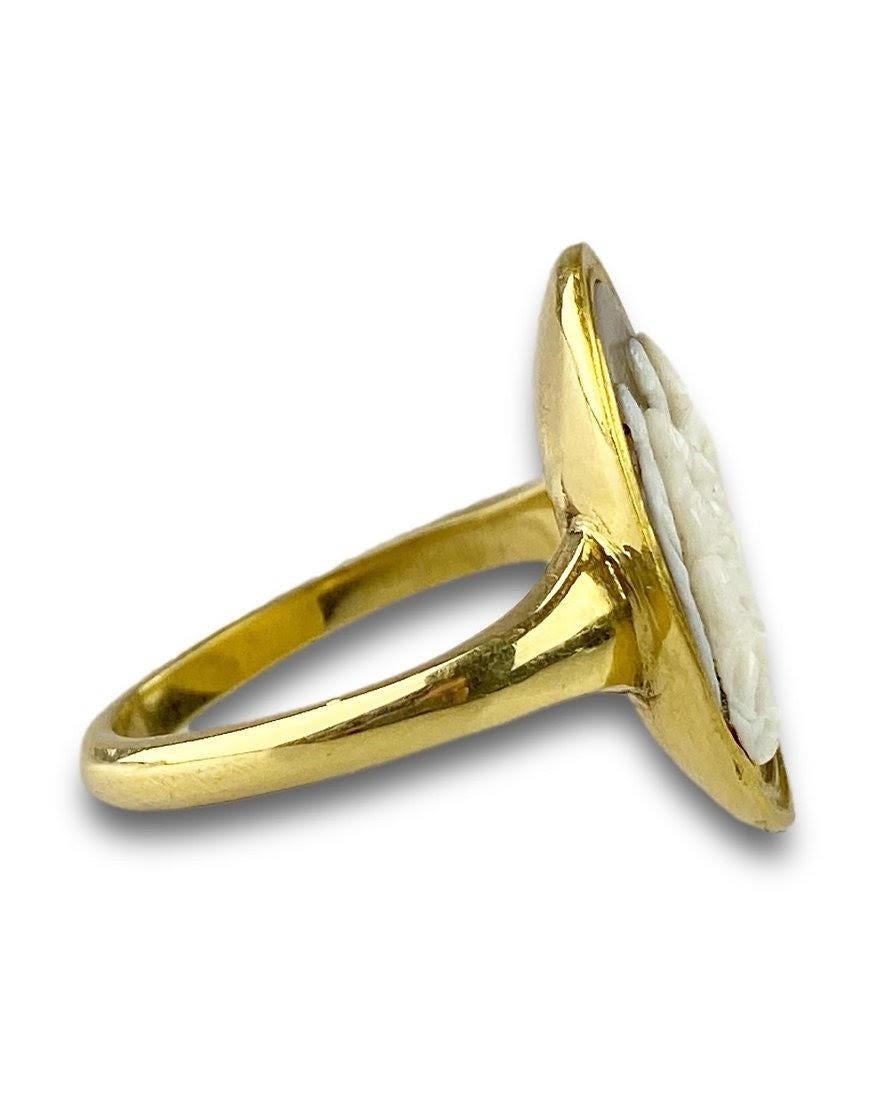 A gold ring set with an agate cameo depicting the presentation of the Christ child at the temple in Jerusalem. 

Italian, circa 1600. 

Set in a high carat gold ring. 

Intaglio alone measures 1.9 x 1.5cm, the ring is a size Q UK / 8 US. 

There is