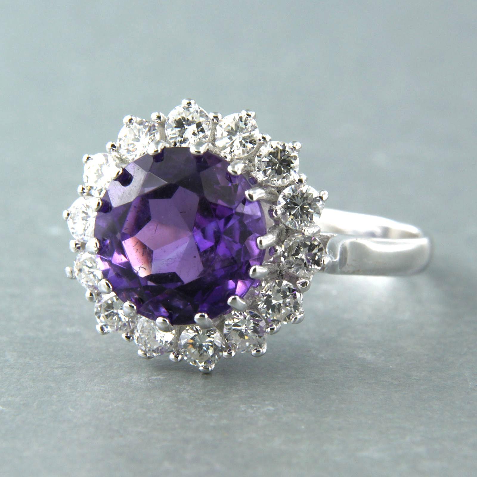 Bague en or blanc 14k sertie d'une améthyste et d'un diamant taille brillant 1.00 ct F/G-VS/SI, taille U.S. 9 - EU. 18.75 (59)

description détaillée :

L'anneau mesure 1,6 cm de large et 9,5 mm de haut. 

bague taille US 9 - EU. 18.75 (59), la