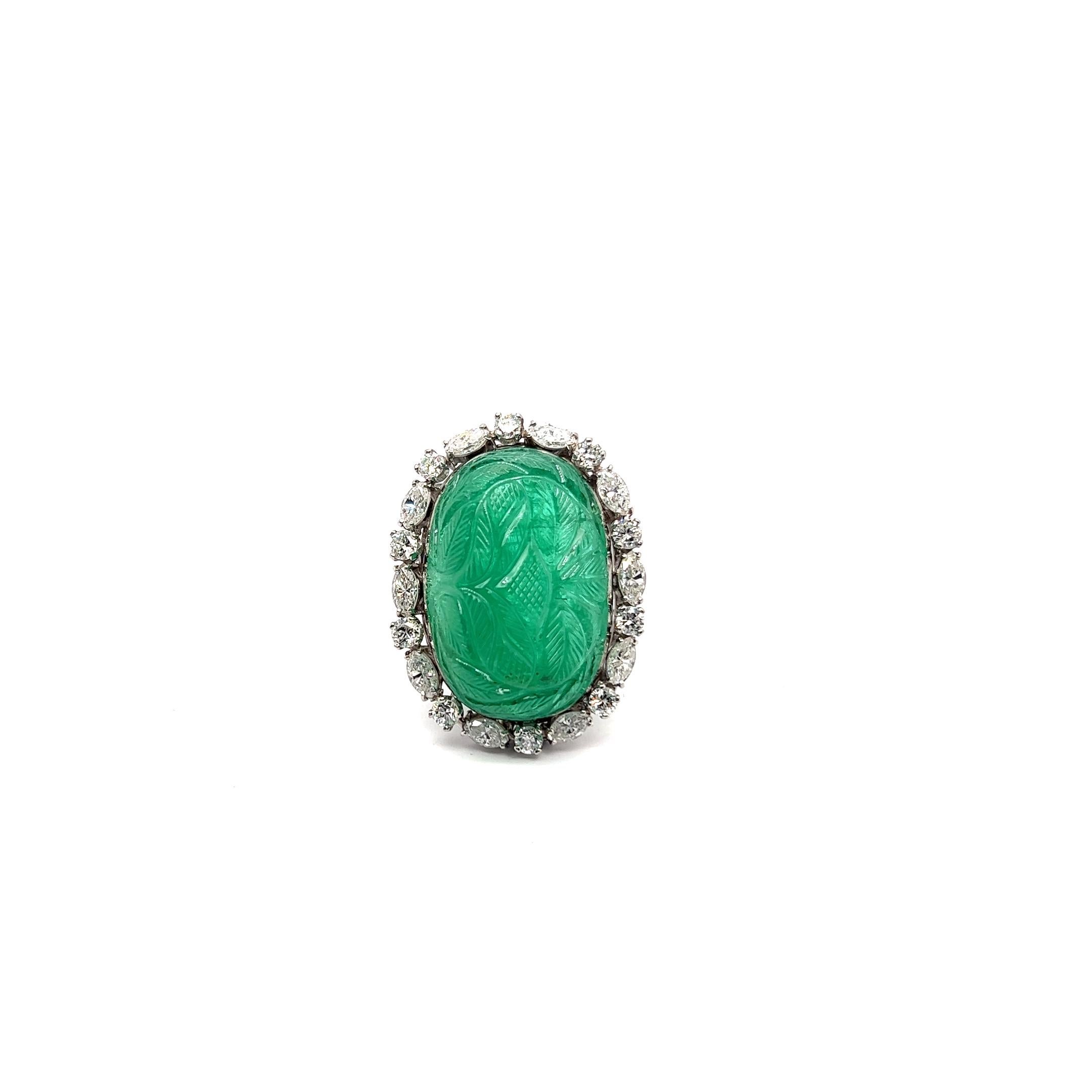 Experience the opulent allure of this emerald ring, celebrating the ancient artistry of gemstone carving. Rooted in history, this tradition began over 5,000 years ago in Ancient Egypt, where skilled artisans adorned themselves with intricately