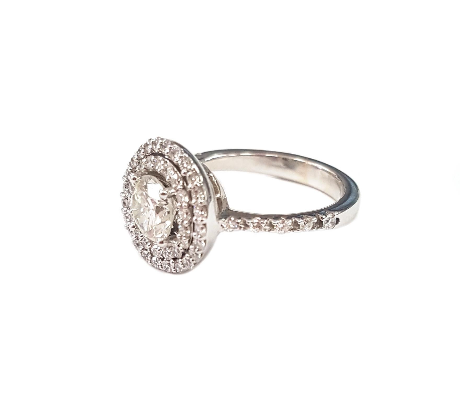 Designed around a central diamond, the double halo and pavé-set band are knockout gorgeous in 18-karat white gold.

A secret feature of the ring is that the inner halo and the centre stone shift and move very slightly. This minimal movement makes