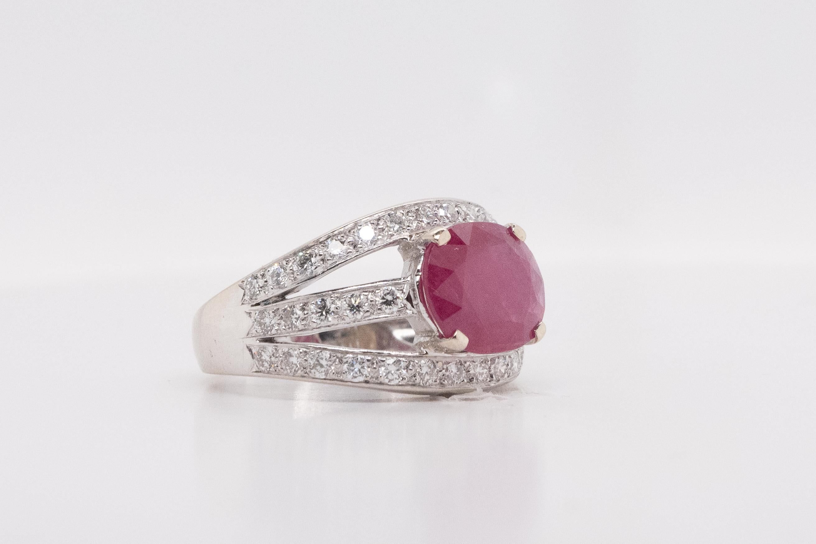 Discover the timeless elegance of our white gold ring, featuring a certified oval-cut ruby weighing 3.19 carats. This exceptional ruby is framed by 42 diamonds, each weighing 0.010 carats, adding a touch of subtle brilliance.

This ring, size FR 51,