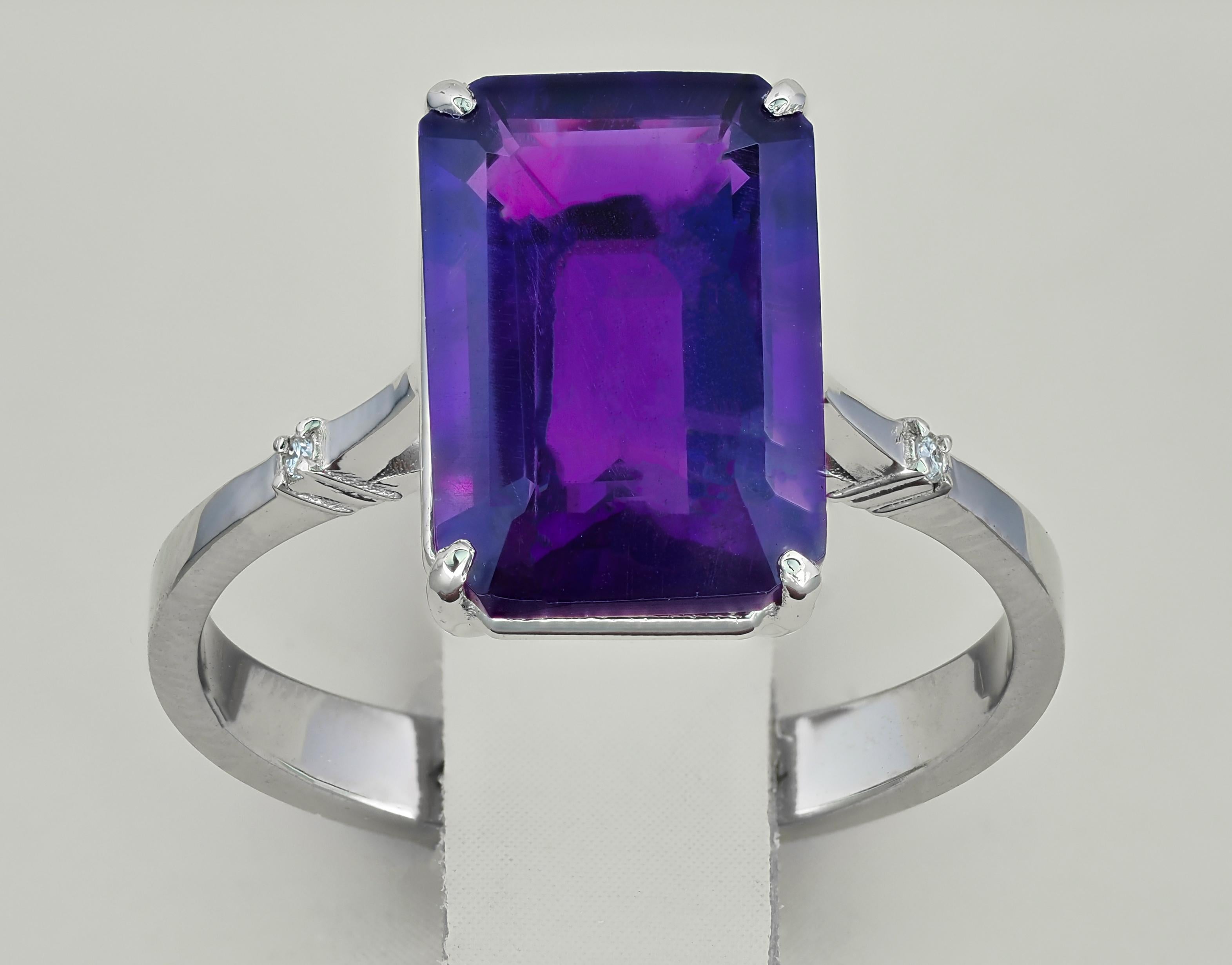 Ring with genuine amethyst and diamonds
Genuine amethyst ring
Metal: sterling silver 
Weight: 3 g. depends from size
 
Set with amethyst, color - violet
Emerald cut, aprox 3 ct. in total (11.5x8.5mm)
Clarity: Transparent with iclusions

Surrounding