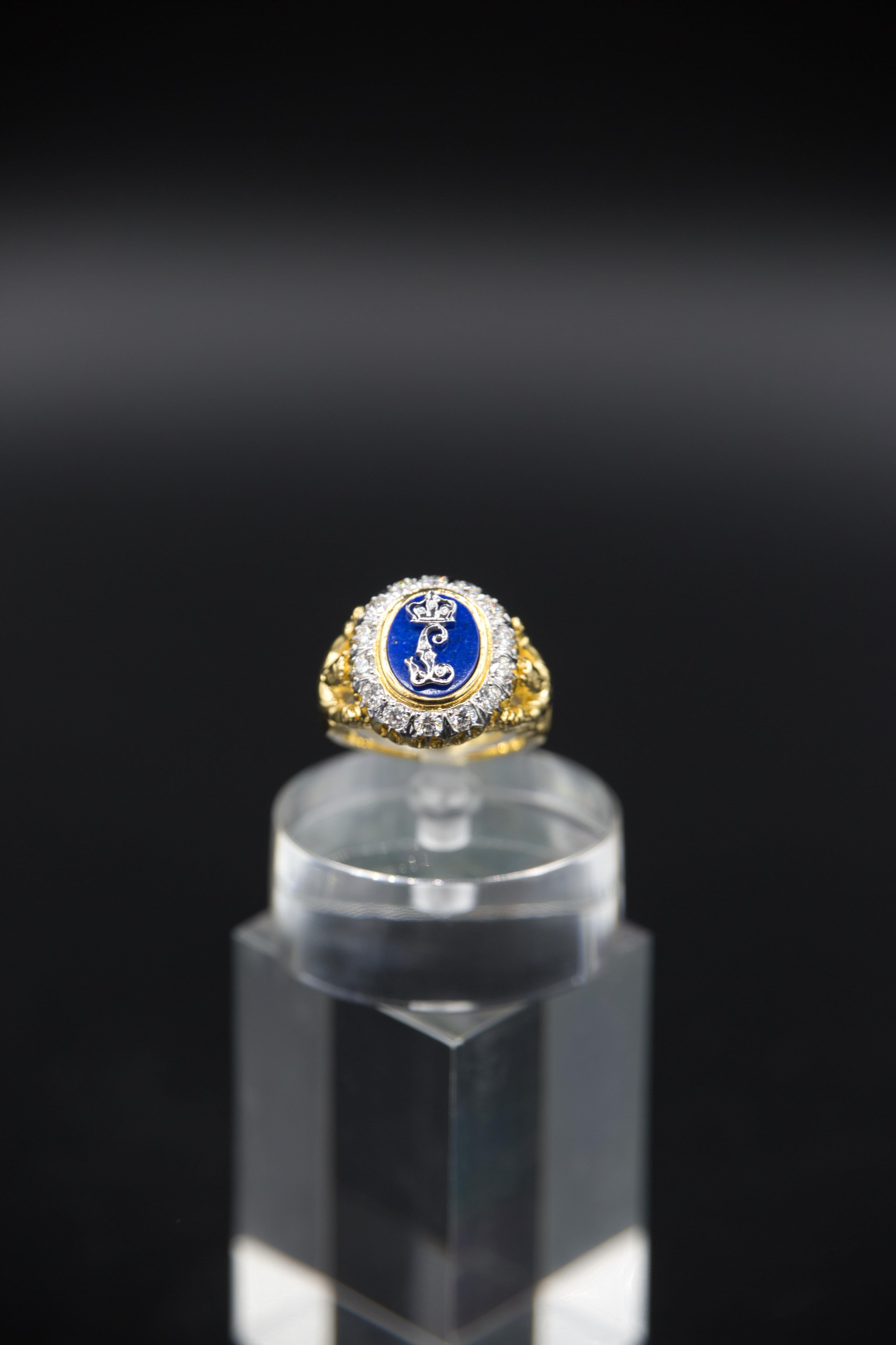 This elegant ring features a unique design. The central monogram 