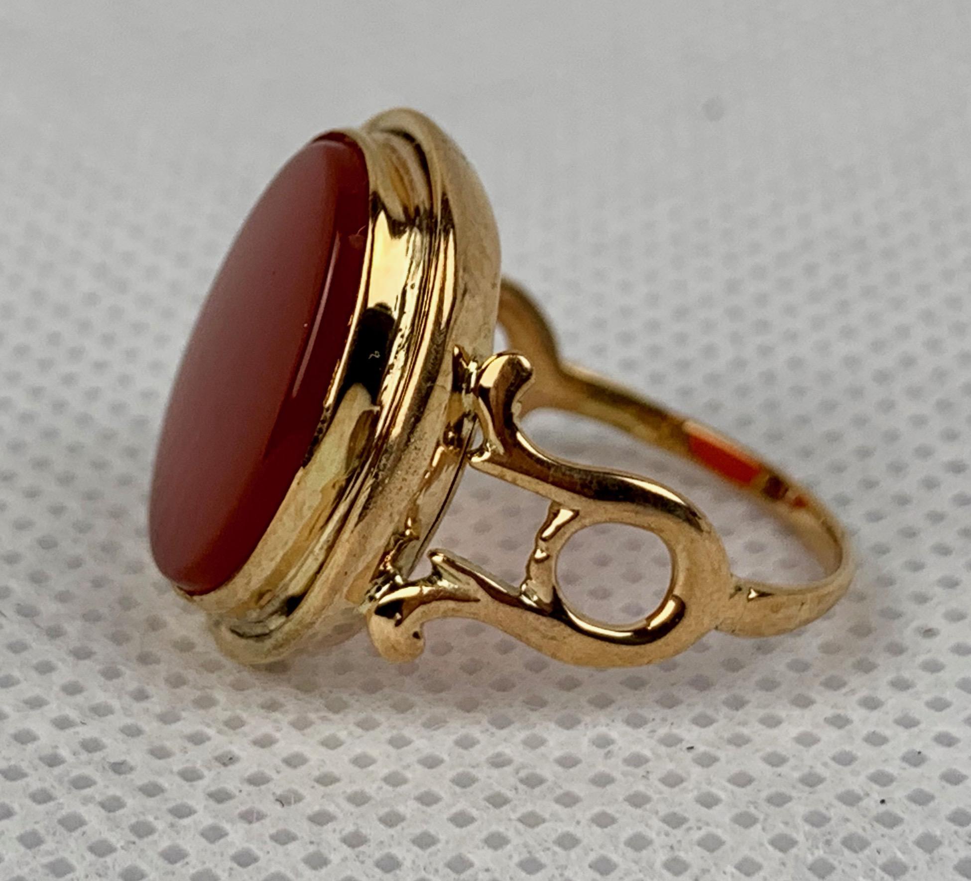 Oval carnelian set into a 14k yellow gold vintage classic ring.  The shank is stylishly simple forming a yoke on each side of the ring and then a circle to grace the finger.  Appropriate for a man or a woman.
Professionally hand polished and