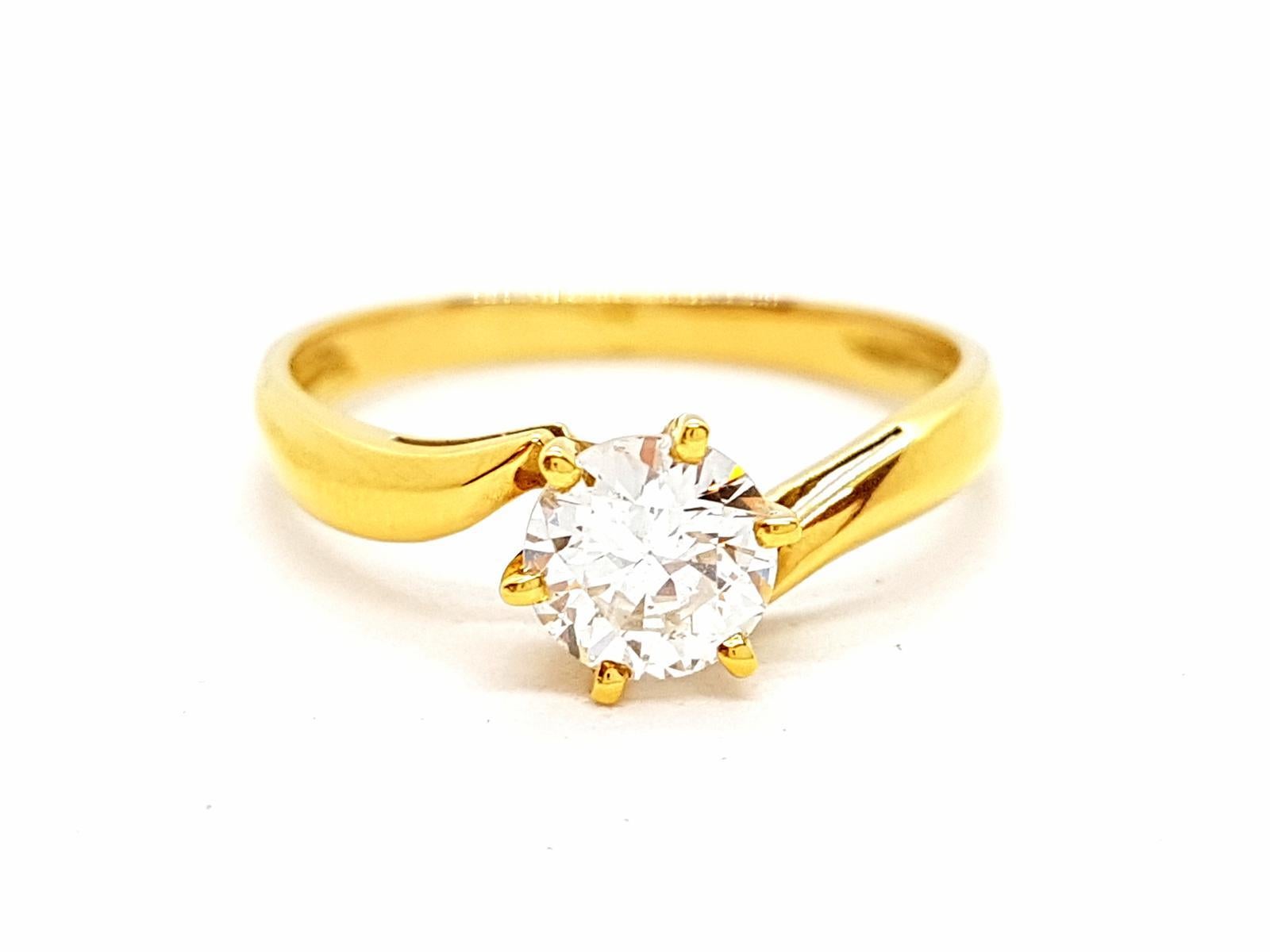 Solitary yellow gold 750 mils (18 carats). set with a brilliant cut diamond GH V-SI 0.71 ct. ring size: 56. width on the top 0.70 cm. total weight: 2.40 g. condition. eagle punch head
