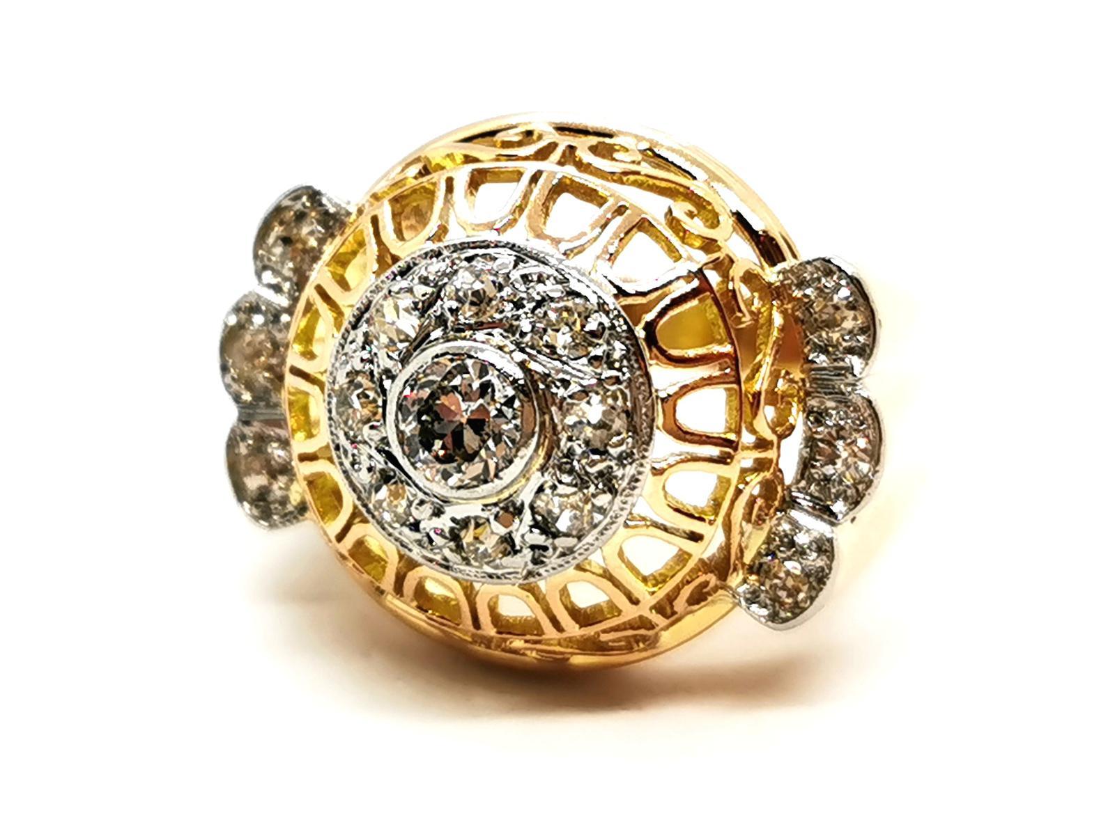 Diamond art deco ring. in 750 thousandths (18 carat) yellow gold and 950 thousandth platinum. openwork curved pattern on top. godronné ring coprs. set in the center on platinum. of a brilliant cut diamond. of about 0.33 ct. supported by 14 antique