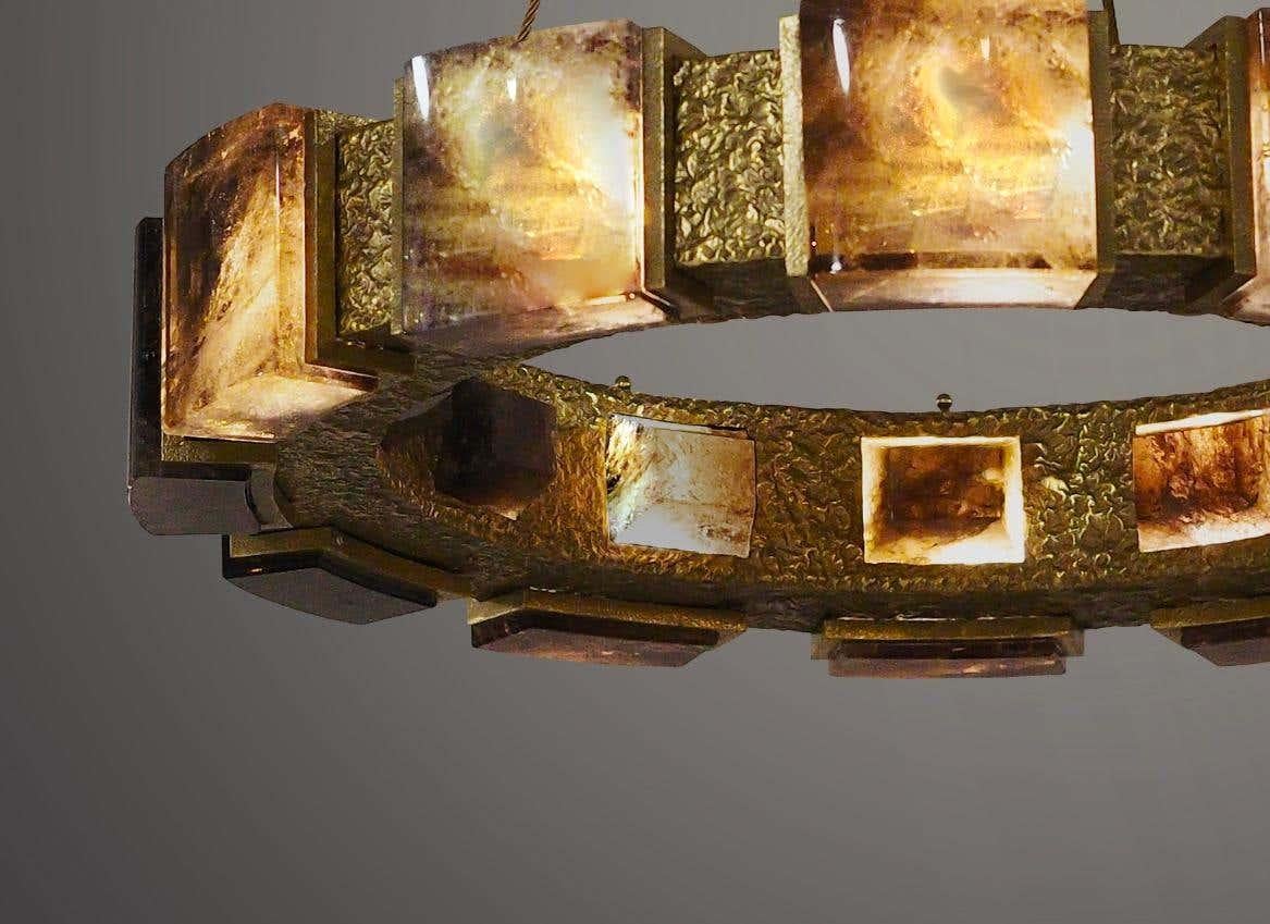 Smoky rock crystal chandelier with hammered brass detail. Created by Phoenix Gallery, NYC.
14 sockets installed. Use 14 candlelabra light bulbs. 60 watts each, total 840W max.
Custom size and finish upon request.