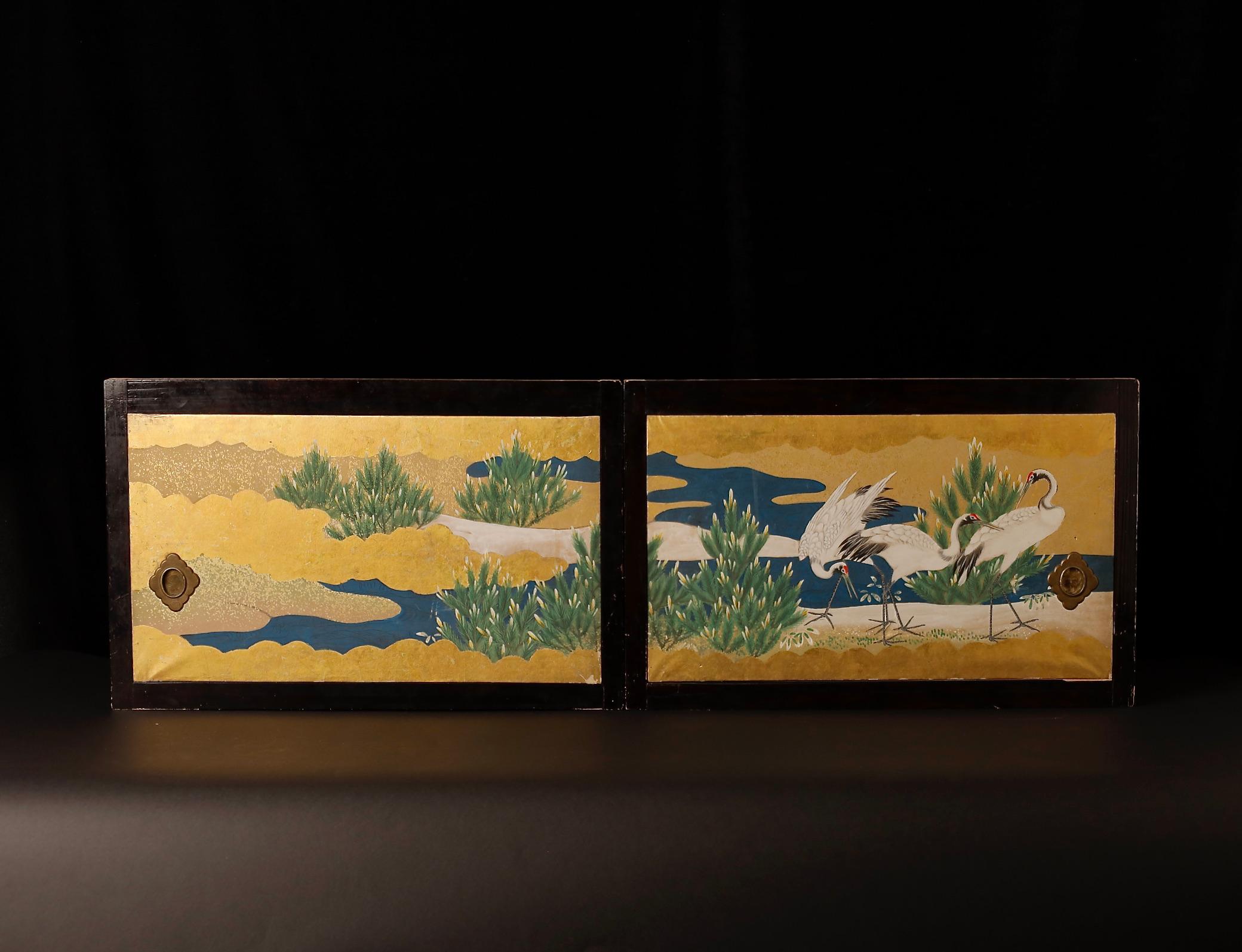 Discover the artistry of traditional Japanese aesthetics with this pair of exquisite sliding doors, dating back to the late Edo period (1800-1850). These doors, adorned with a Rinpa-style painting, feature a tranquil scene of majestic cranes over a