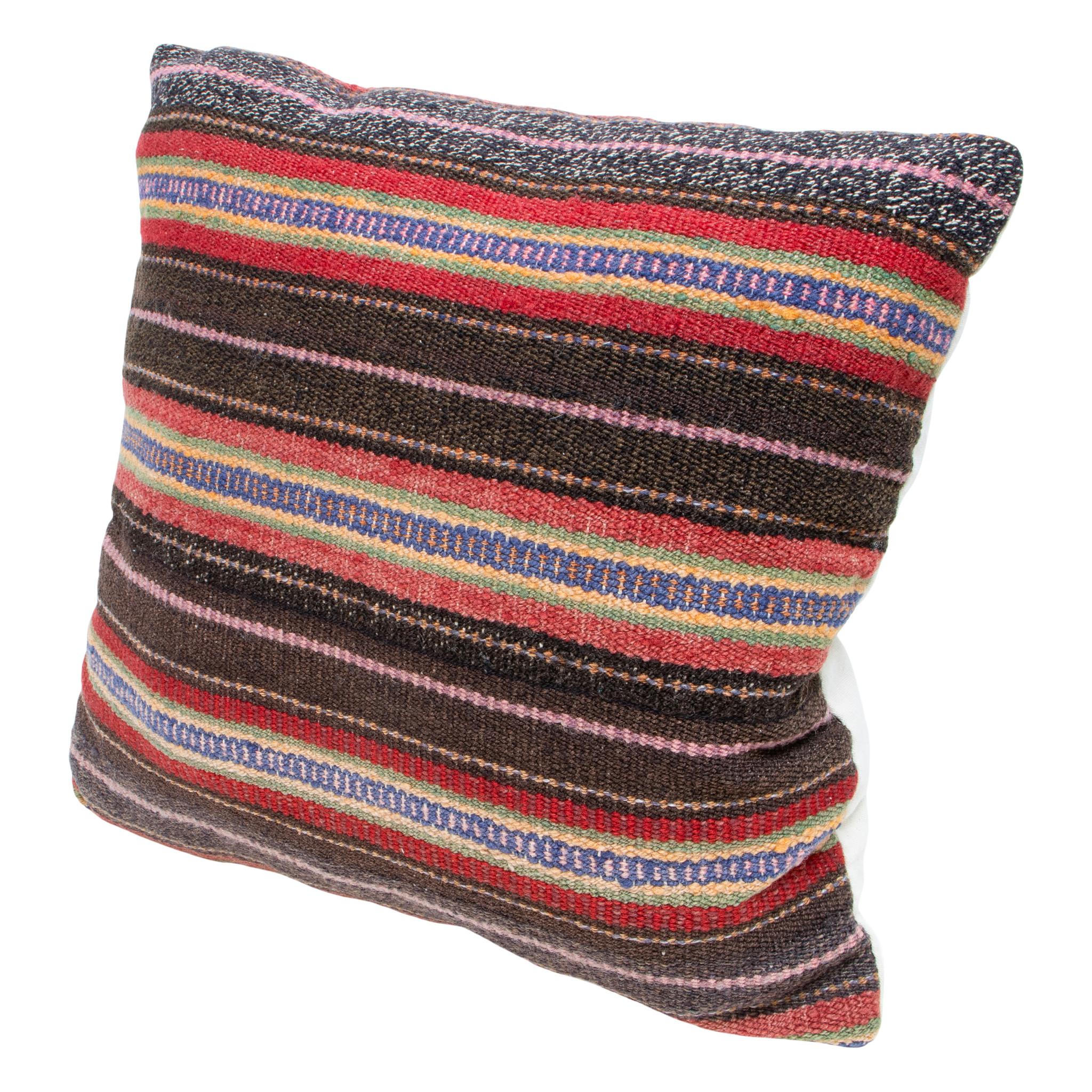 Rio grande weaving lodge pillow. Handmade pillow with front made of half Rio Grande 1880's weaving and half warm toned leather. Backed with canvas. Featuring natural dyed colors of brown, blue, green, yellow, pink, and black. 18