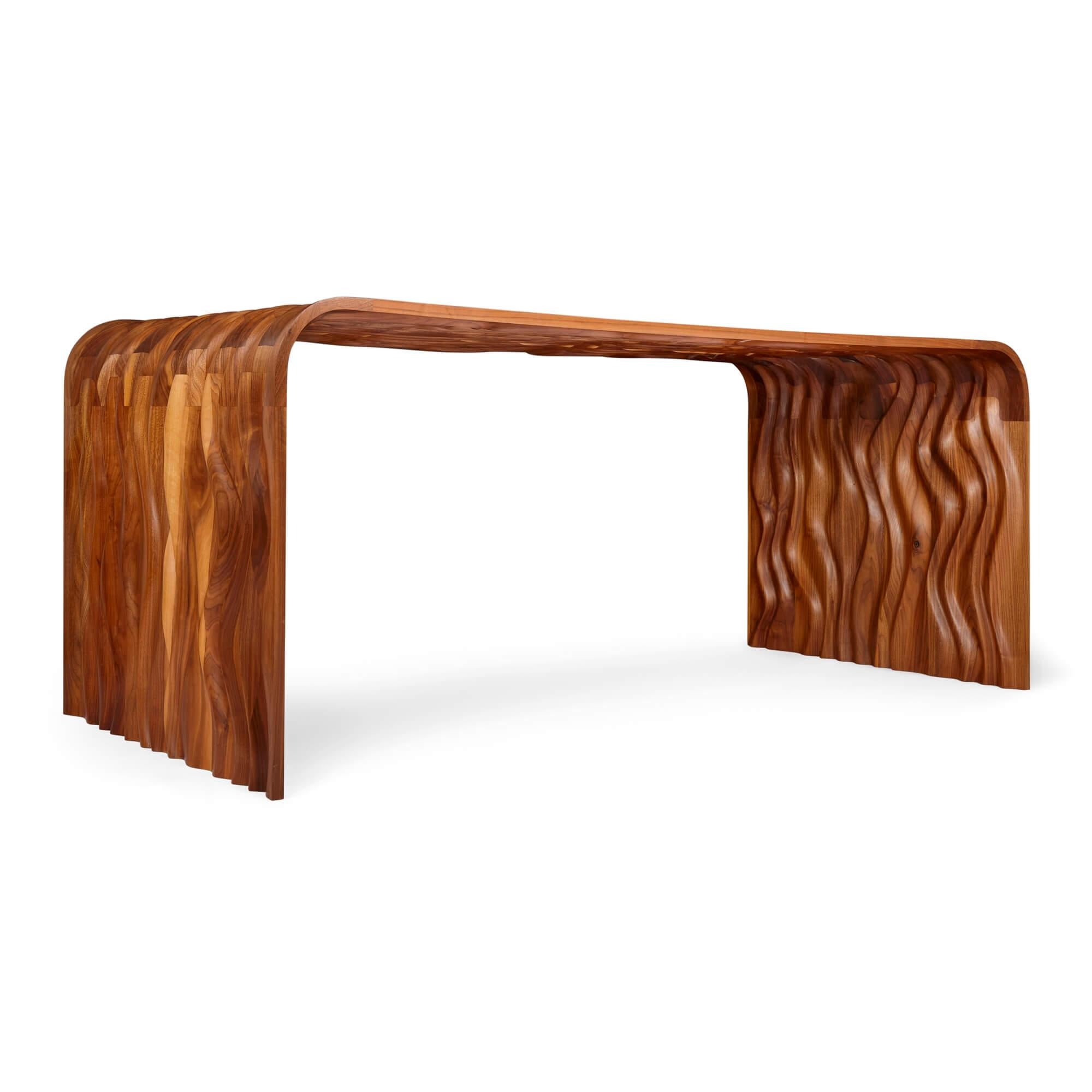 'Ripple' black walnut desk by Tom Vaughan 
British, 21st Century
Height 70.5cm, width 179cm, depth 81.5cm

This intriguing contemporary desk was expertly designed and made by the British designer Tom Vaughan (b. 1976). 

The overall shape of the