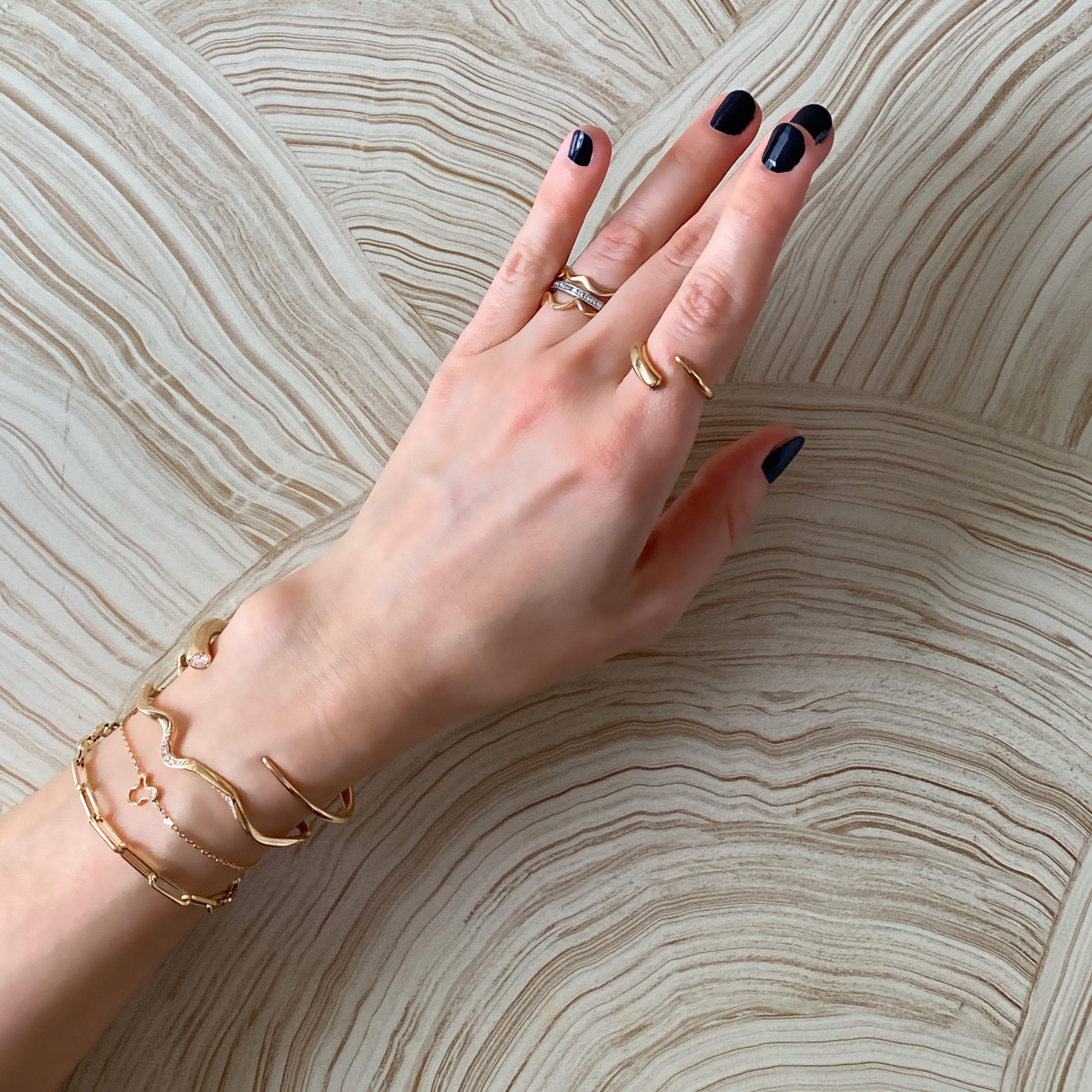 - 14k recycled yellow gold
- Ripple length: 9mm
- Bracelet length: 7 inches (adjustable up to -2”)
- Ethical diamonds
- Total carat weight: 0.04 carat
- Made in NYC

Wear our 'Ripples' as a reminder of your feminine strength and power. We love this