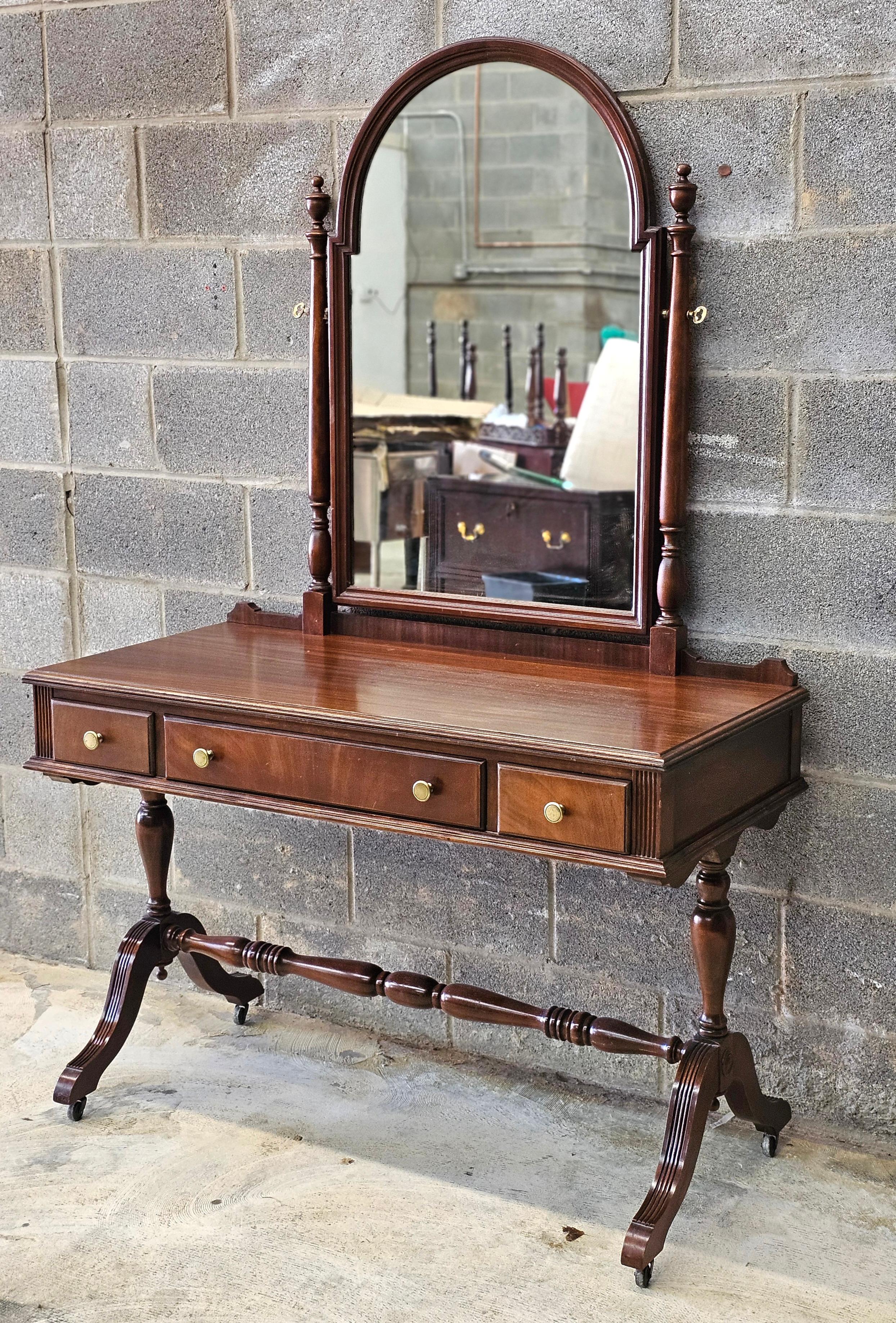 J. K . Rishel Furniture Mahogany Rolling Stretcher Mirrored Vanity Dressing Table. Measures 44.25