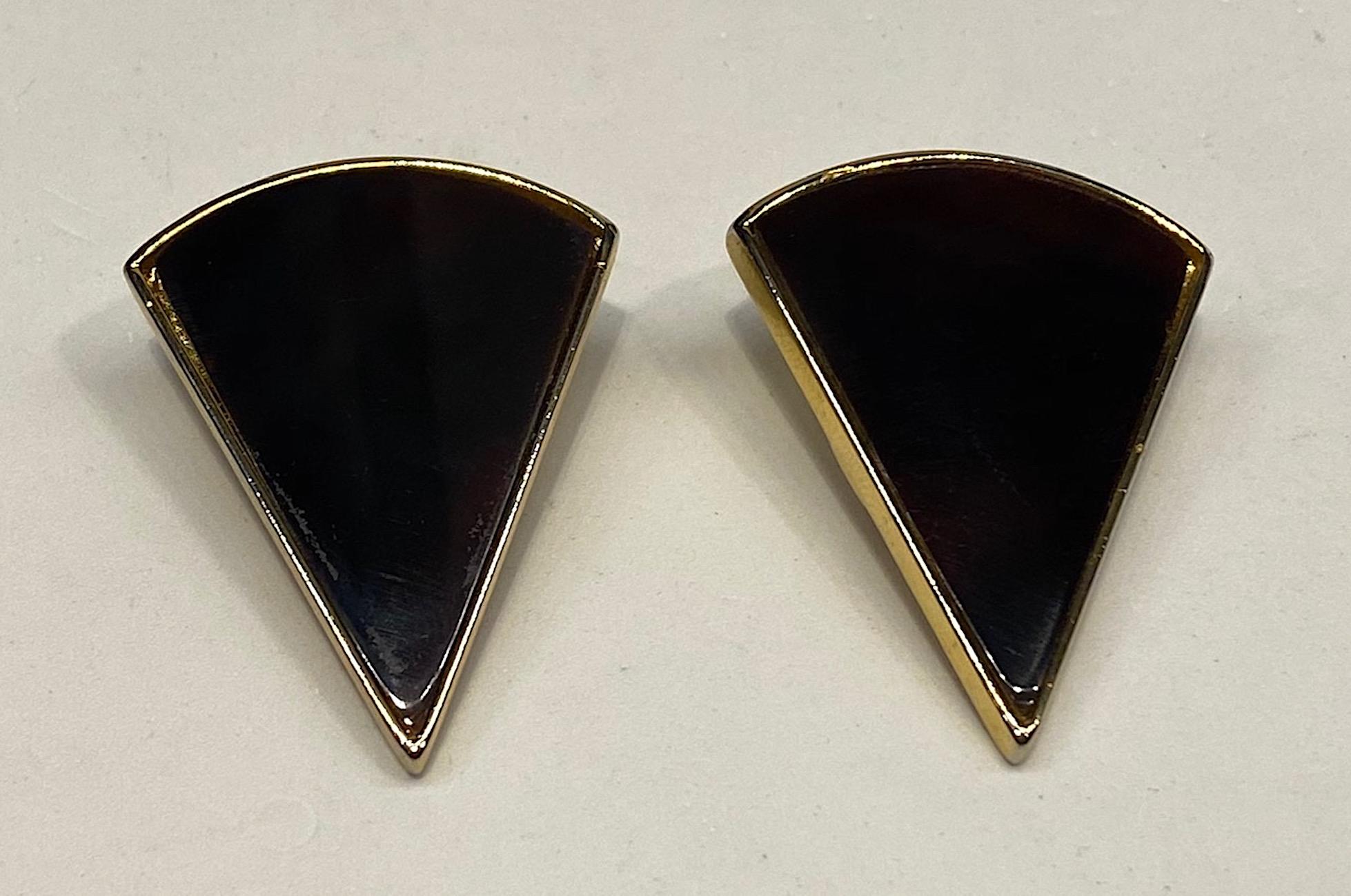 A stunning pair of 1980s pie shape clip earrings by Italian designer Rita Frascione of Firenze, Italy. The gold tone earrings are 1.5 inches wide and 2 inches long. Each is inset with a pie shape dark caramel and chocolate color glass pieces to