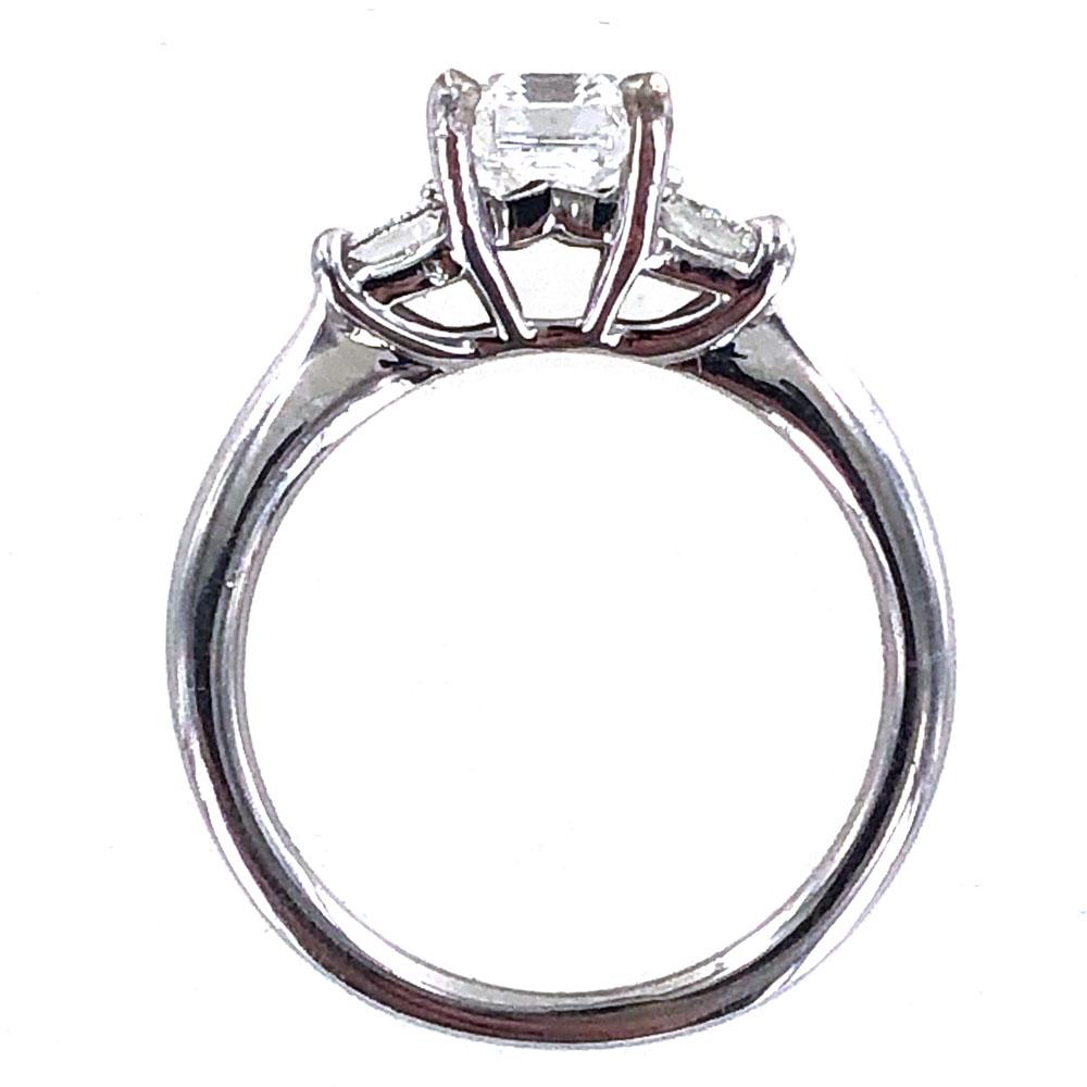 Gorgeous emerald cut diamond engagement ring set in an 18 karat white gold Ritani mounting. The 1.17 carat emerald cut diamond is graded D color and SI1 clarity by the GIA. The mounting features two princess cut diamonds weighing .46 CTW. The ring
