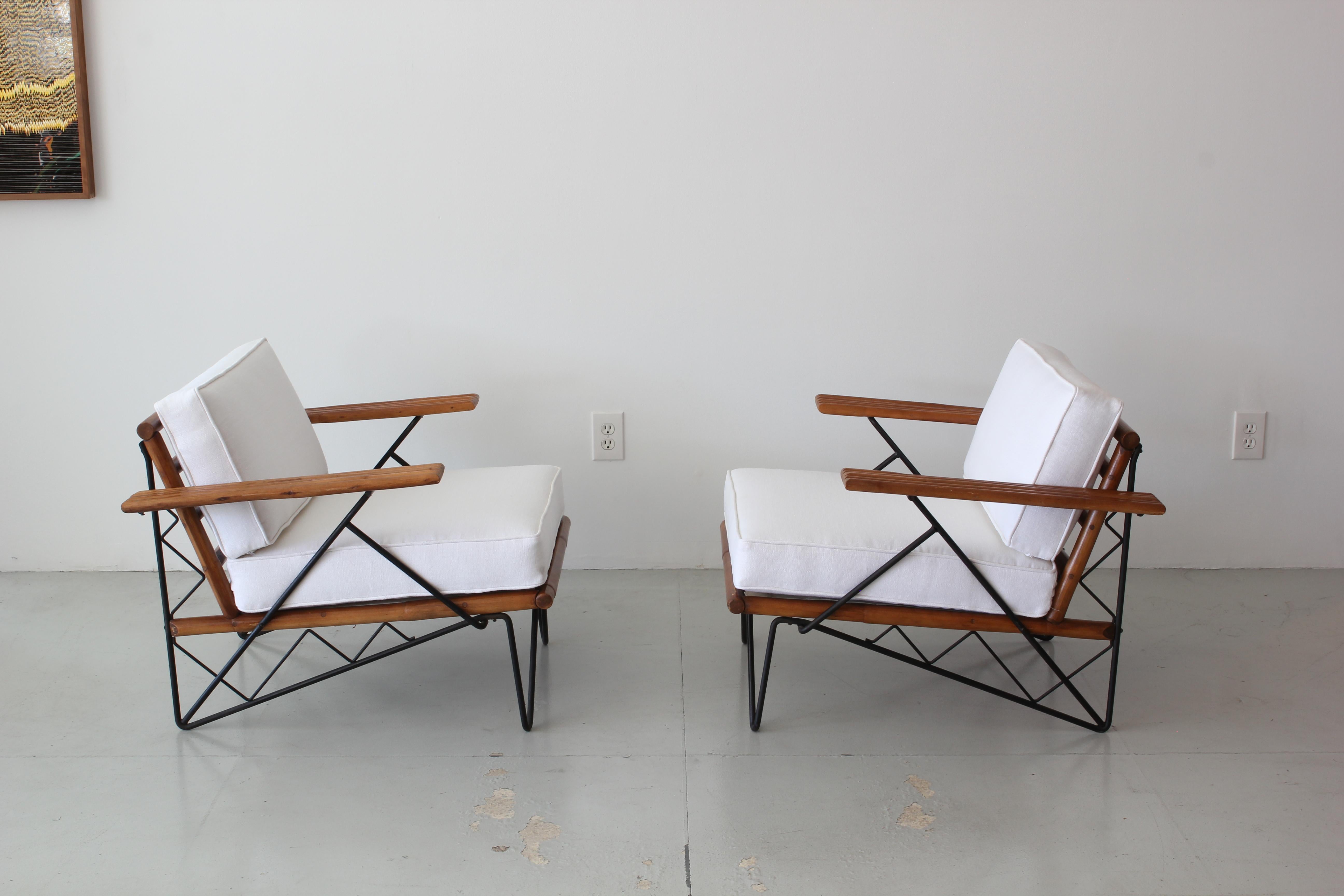 Pair of chairs from Ritts Furniture company, circa 1960s.
Interesting iron base
Rattan arms and slatted back
Newly uphostered in white linen.
