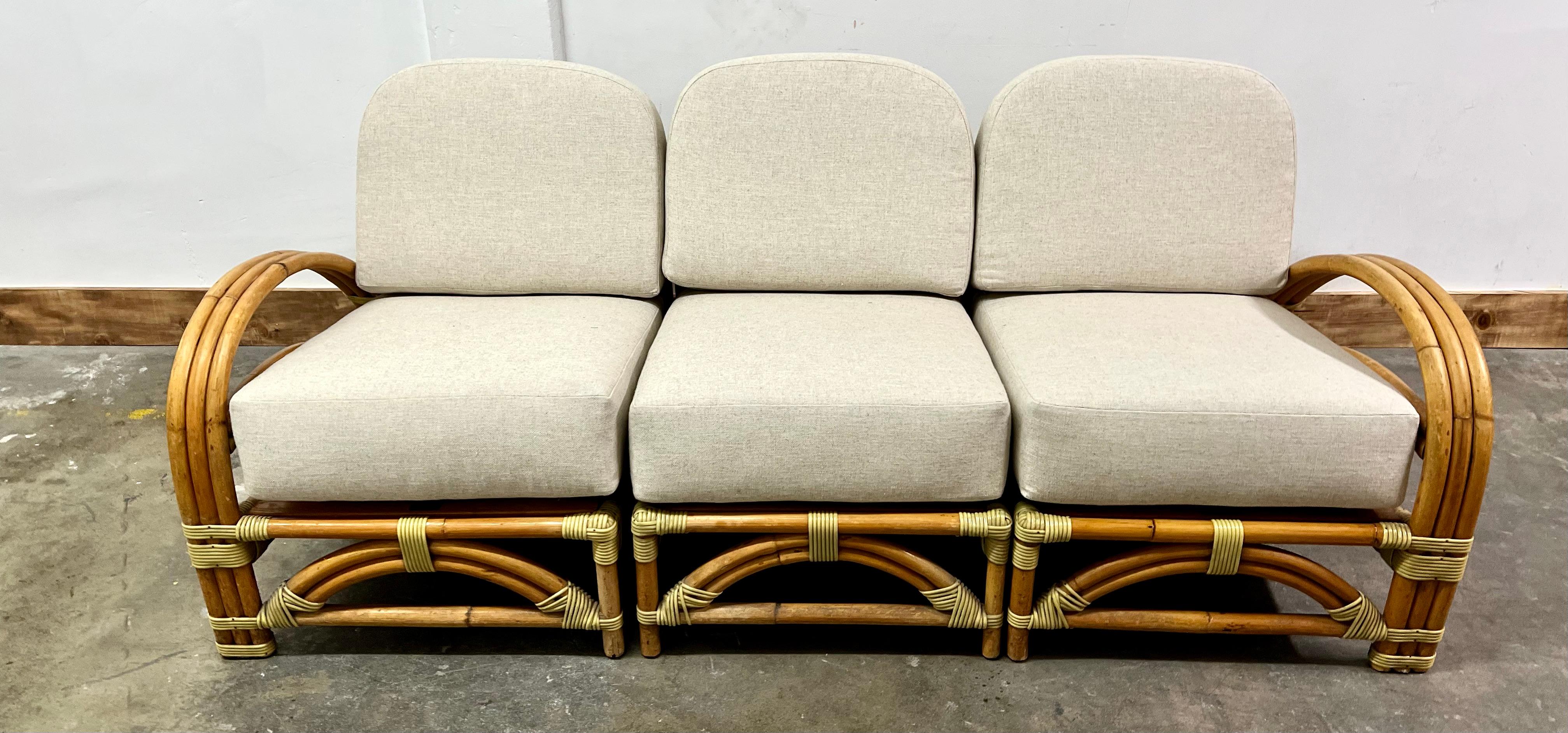 Ritts and Co. Rattan sofa with new raw cotton upholstery. The sofas comes in three sections that are independent but form a lovely Sofa. Ritts and Co. produced wonderful and iconic mid century pieces, from acrylic to Rattan... their pieces stand