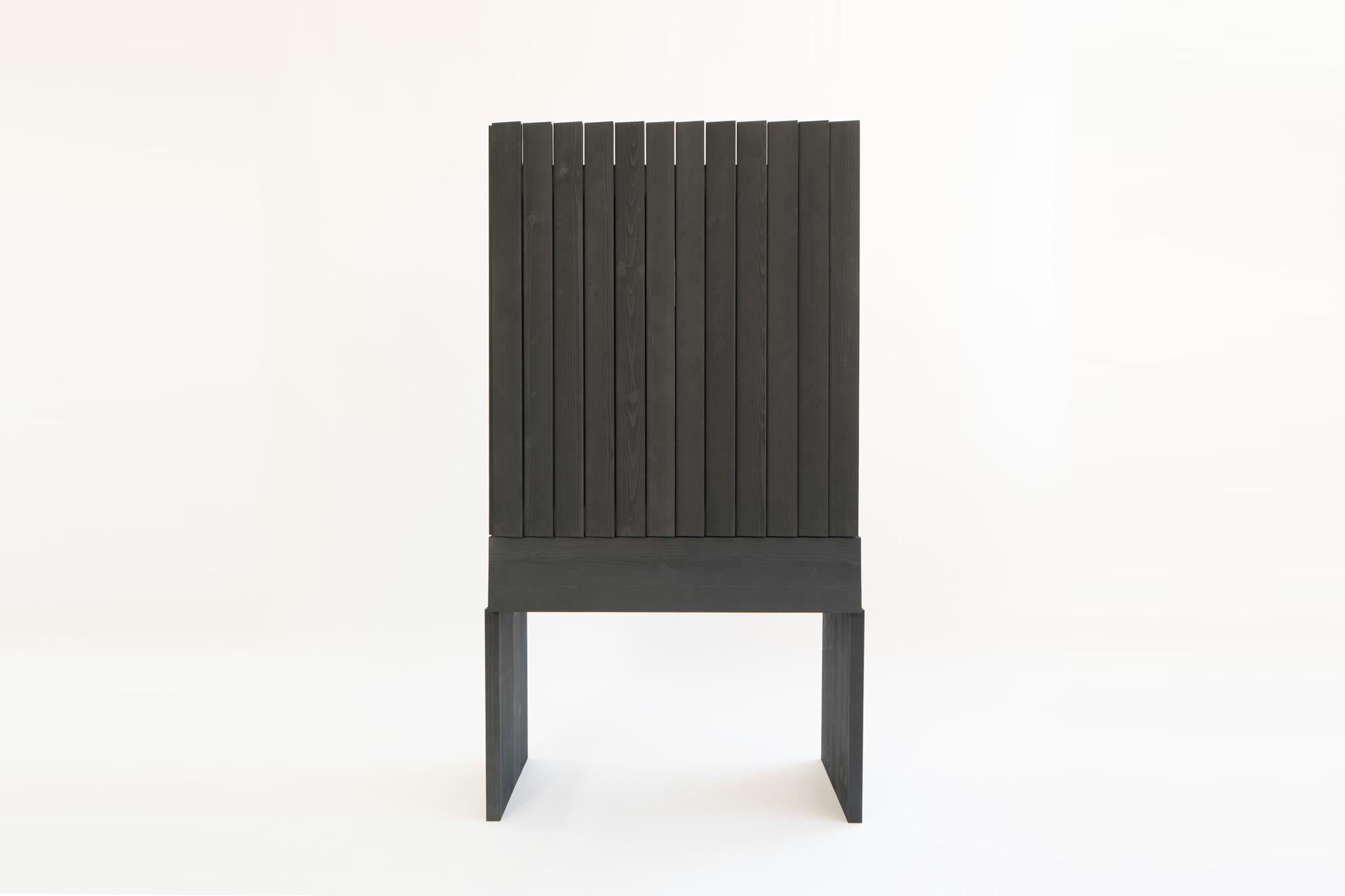 Ritual cabinet by Jude Heslin Di Leo
Dimensions: W 102 x D 51 x H 183 cm
Materials: Ink dyed Hemlock, Blackened Steel & Bronze Mirror

Ritual Cabinet is an exploration in contrast. Utilizing humble materials and high aesthetics it presents a