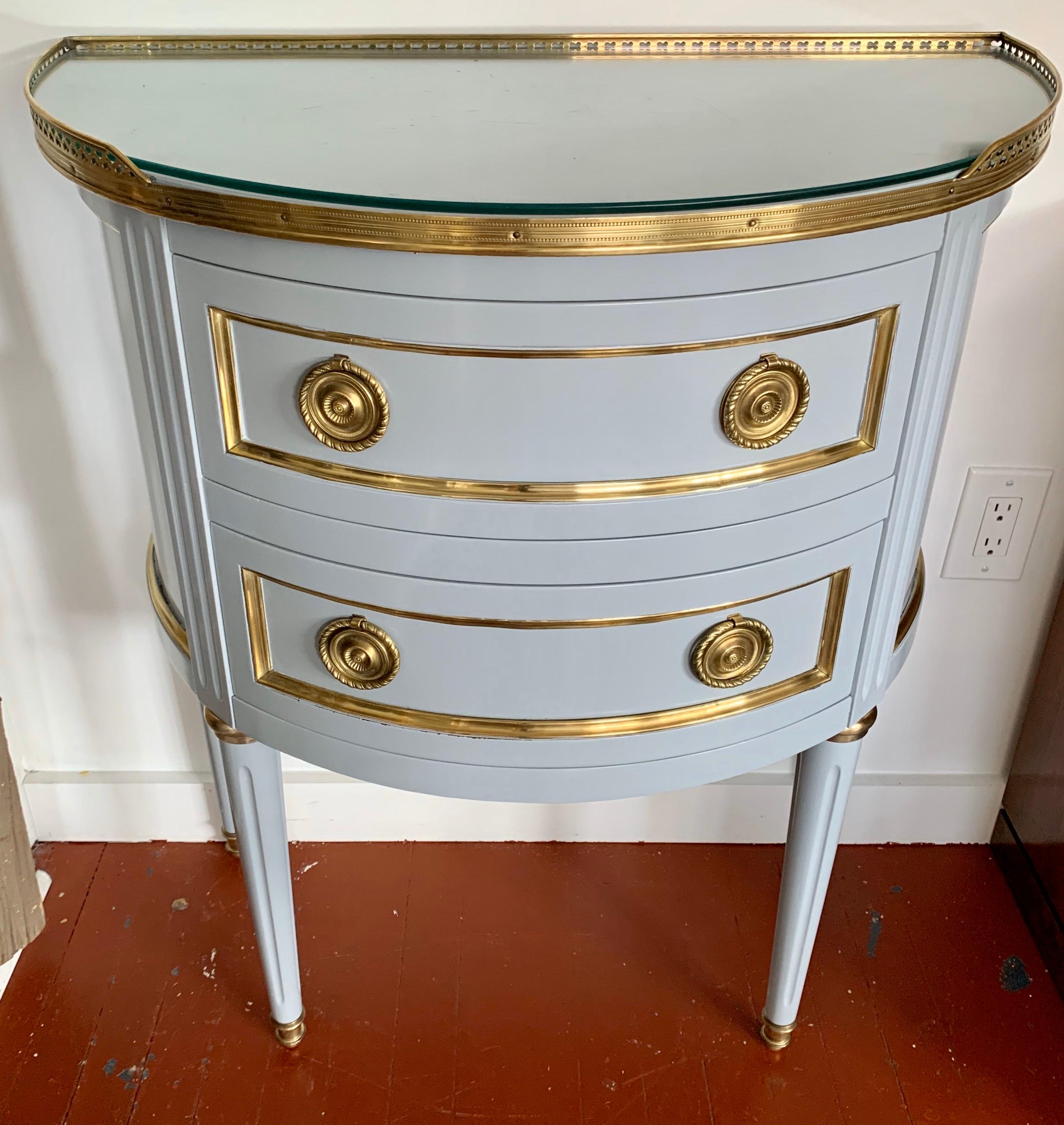 Stunning newly lacquered small demilune chest that originally came from the Ritz Carlton Hotels.
The powder blue lacquer has hints of gray and the brass is gorgeous. Great lines and better scale.
It features two drawers for storage.