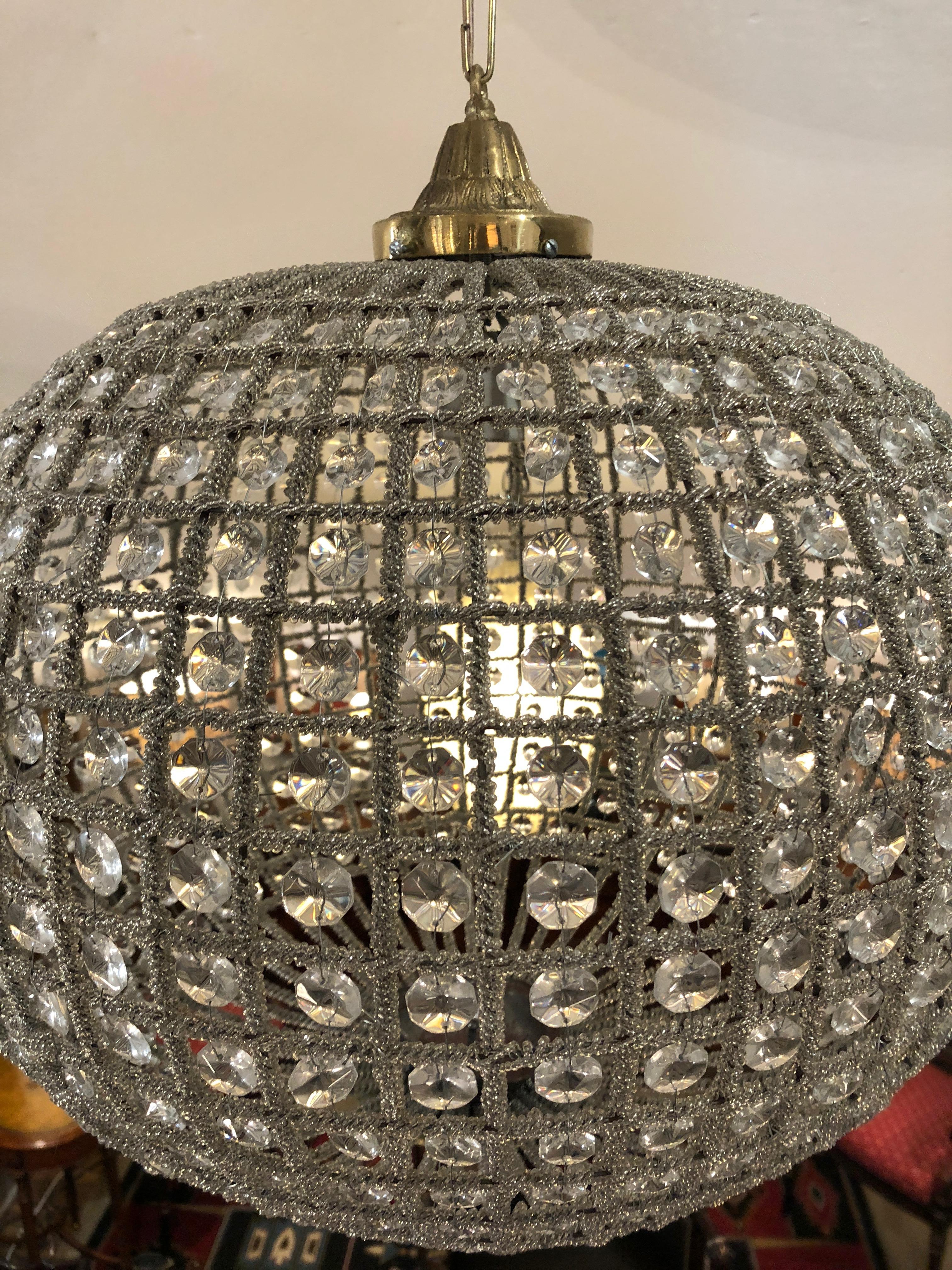 Moviestar glamorous sphere shaped orb having a silver wire and beaded mesh frame, embellished with dozens of glistening crystals.