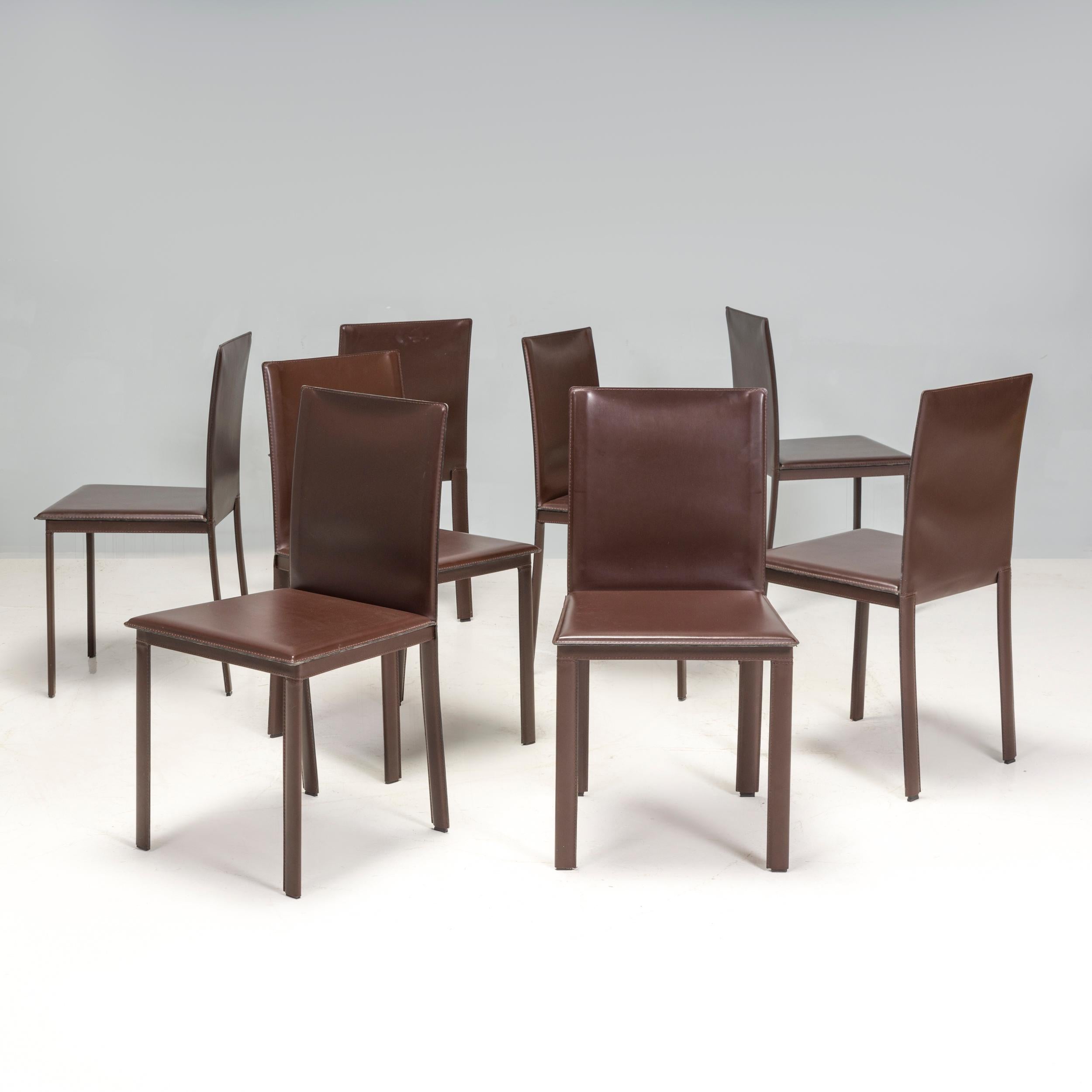 The Riva 1920 Dining Chairs sleek, contemporary silhouette. Their seat cushions are padded and upholstered in deep brown leather for additional comfort, and have a glossy finish that adds to their sophisticated style. Meanwhile details such as the