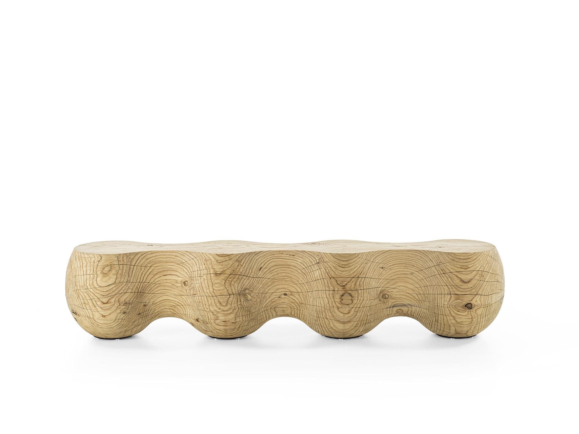 Riva 1920 BRUCO Bench
Design: LCB.2M

The BRUCO Bench is a sculptural seat carved from a single block of solid Lebanese cedar. Its distinctive design is defined by the harmonious fusion of four rounded spheres, evoking the organic silhouette of a