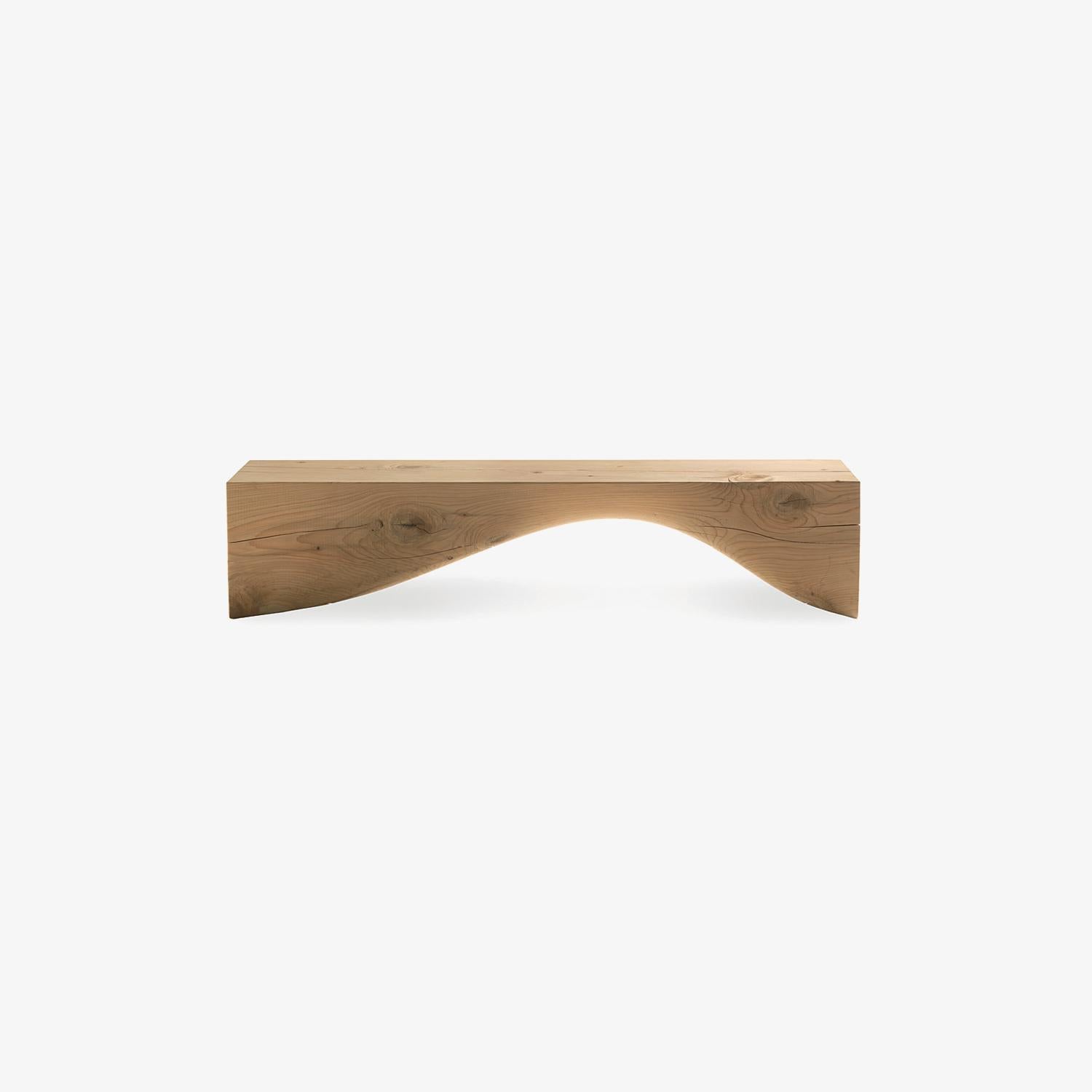 The Curve Bench, designed by Brodie Neill for Riva 1920, is an extraordinary expression of sculptural design and fine craftsmanship. Hand-carved from a single block of scented solid cedar wood, it celebrates the natural fragrance, warmth, and unique