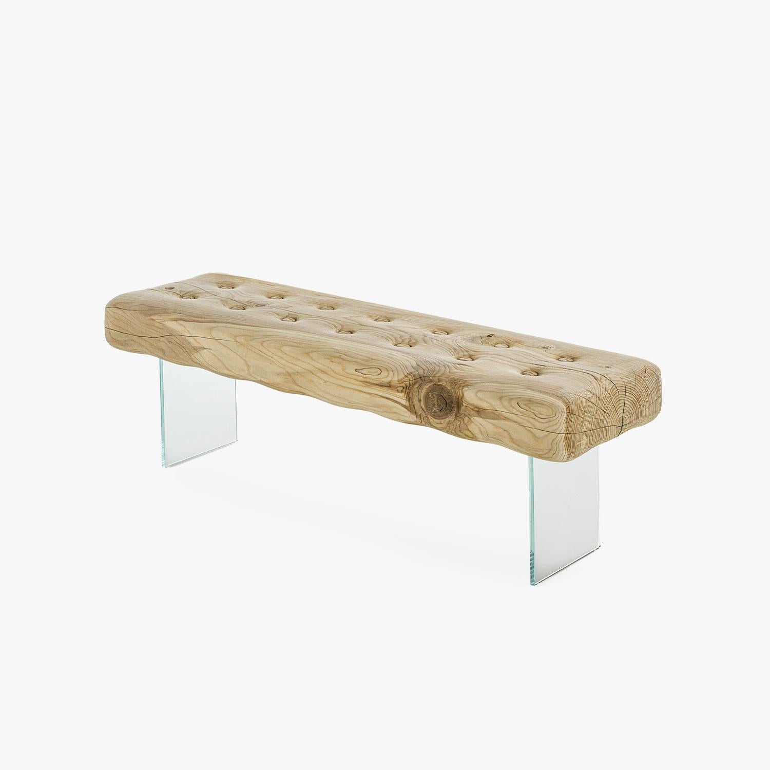 The Giacinto Bench, designed by Studio AMeBE for Riva 1920, is a striking exploration of form, contrast, and craftsmanship. Carved from a single block of scented solid cedar, the seat evokes the shape of a mattress, creating an intriguing tension