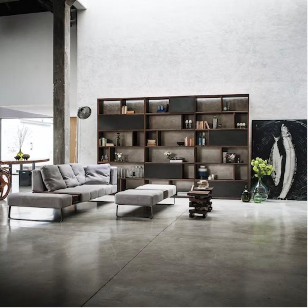 This modern sofa, created by Terry Dwan, has a sleek and fashionable shape that exudes a sense of style. The white Crystal leather upholstery is beautifully enhanced with a streamlined channel design. It stands on a sturdy iron base, ensuring