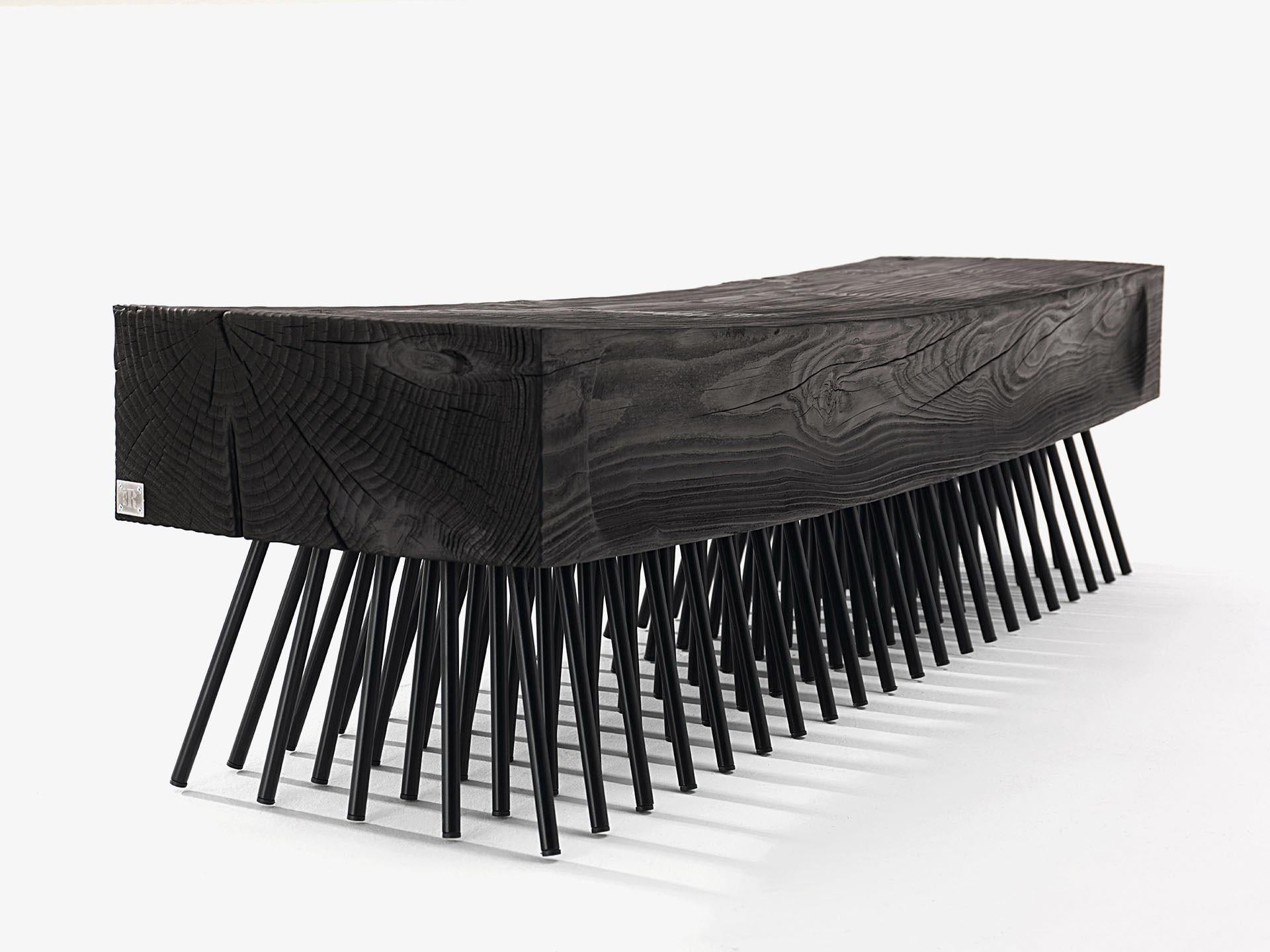 The Spazzola Bench, designed by Fabio Lo Jacono for Riva 1920, is a striking example of sculptural craftsmanship and functional design. Handcrafted from a single block of scented solid cedar wood in the Cedro Vulcano finish, the bench celebrates the