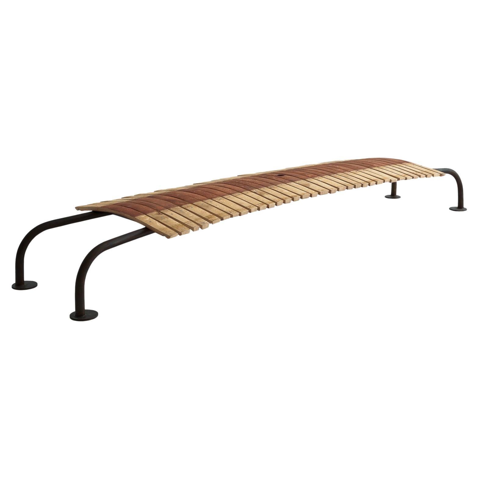 The Tommy Bench, designed by Riccardo Arbizzoni for Riva 1920, is a masterful combination of reclaimed materials and contemporary design. Its seat is crafted from Barrique oak slats, meticulously assembled to highlight the natural grain, texture,
