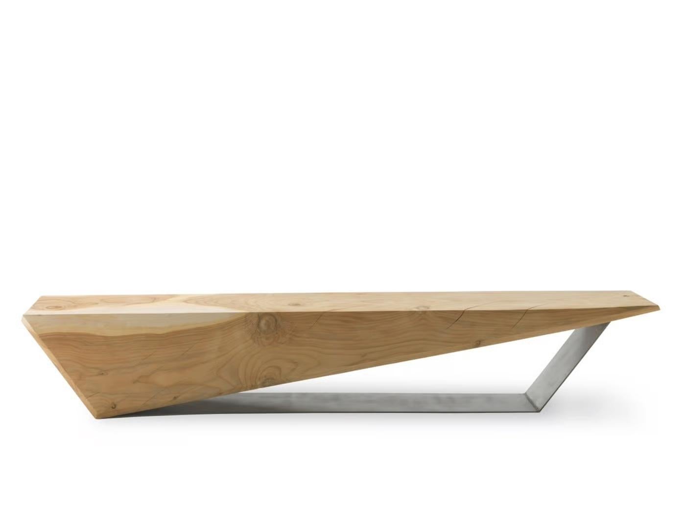The Wedge Bench, designed by Boyan Grigorov for Riva 1920, is a refined expression of minimalist geometry and artisanal excellence. Carved from a single block of scented solid cedar wood, it enhances the natural warmth, fragrance, and distinctive