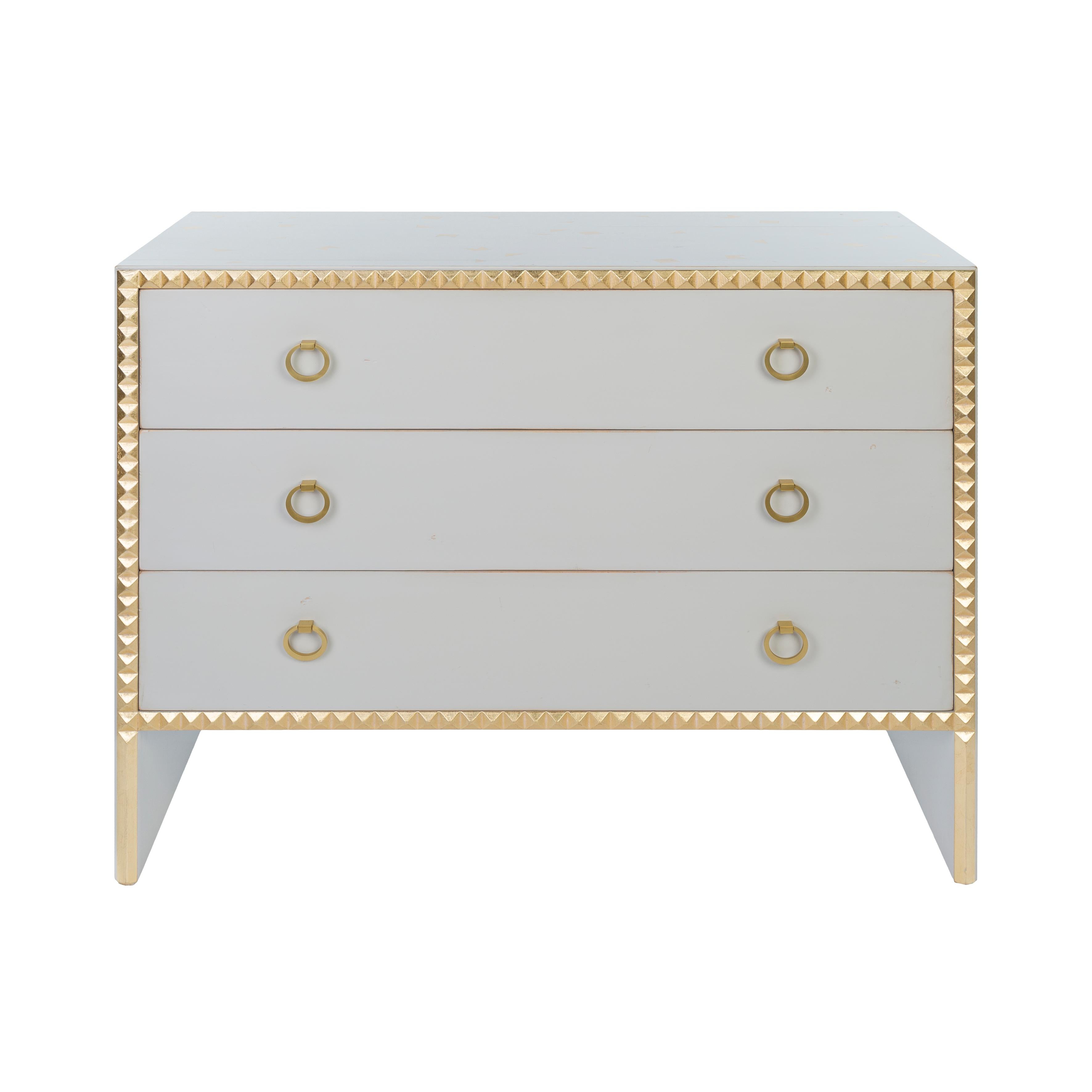 Gris Couture lacquered beech chest-of-drawers. Three drawers on metal rails. Diamond-tipped edgings enhanced with gold highlights. Proposed with a gold stencil decoration. 
It is a piece of furniture made by hand by the craftsmen of Moissonnier, a