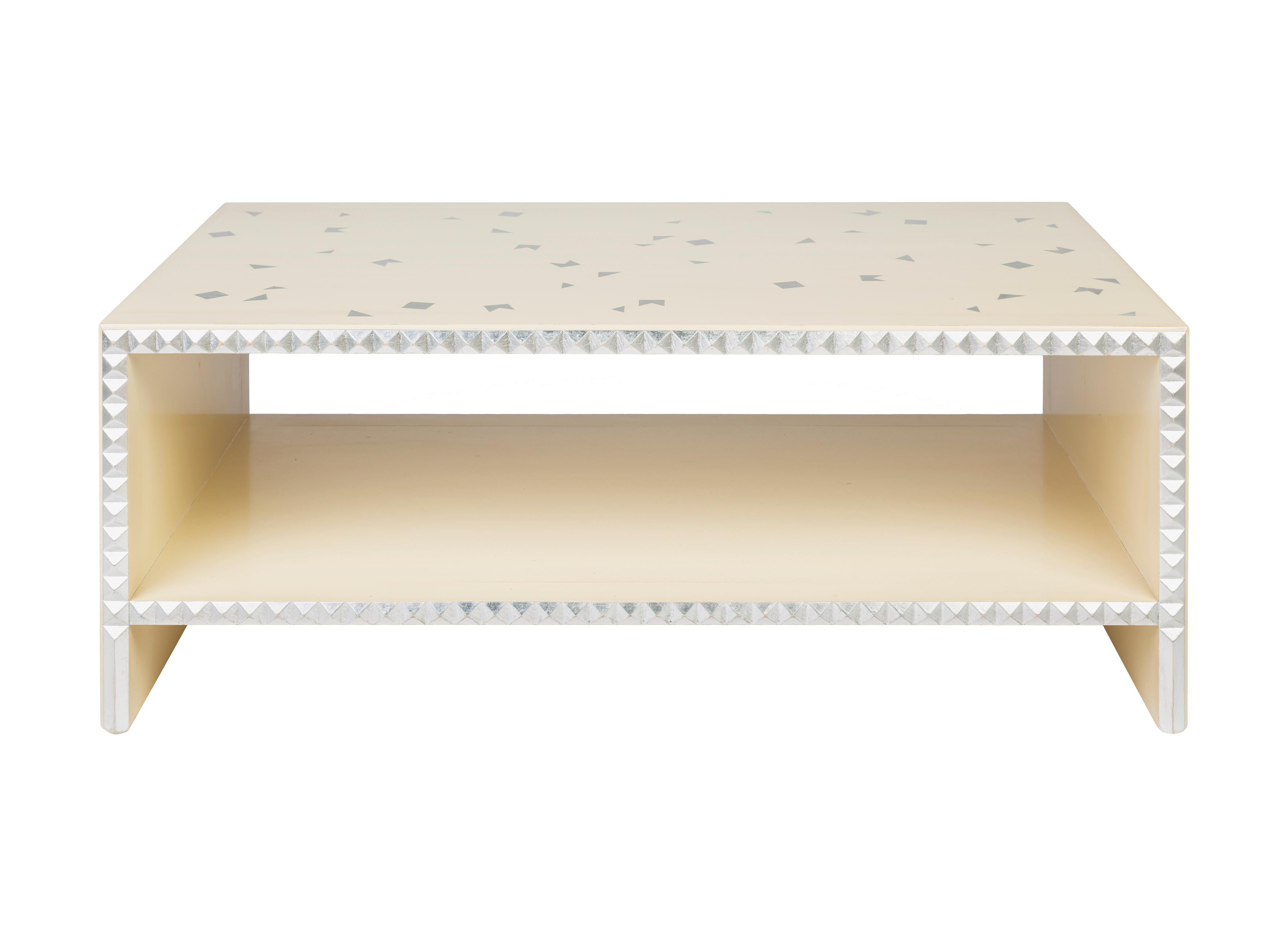 Ivoire lacquered beech coffee table. One shelf. Diamond-tipped edgings enhanced with silver highlights. Proposed with silver stencil decoration. 
It is a piece of furniture made by hand by the craftsmen of Moissonnier, a French cabinetmaker since
