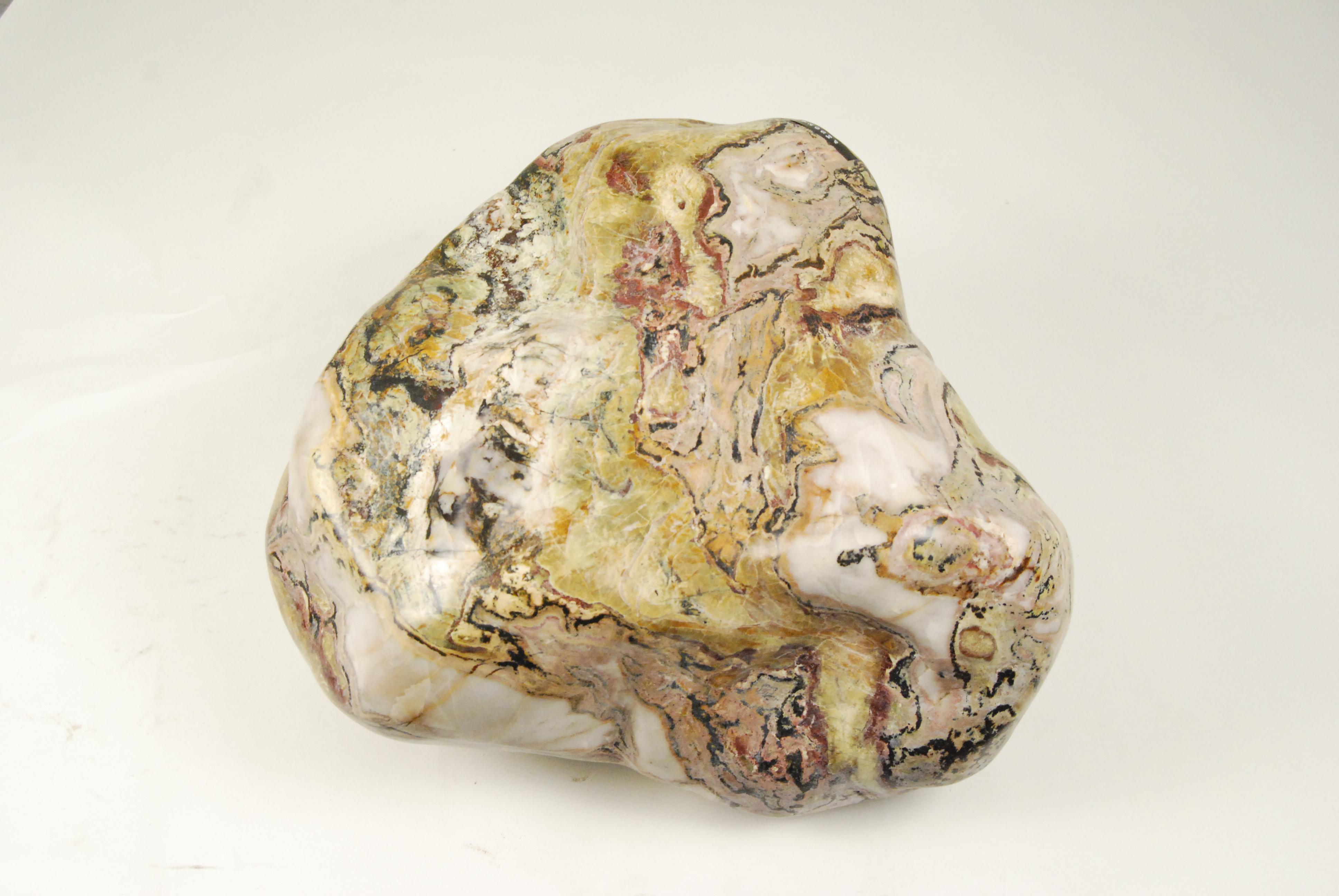 Cloaked in swirling colors and an undeniable sense of depth, scholars' rocks such as these were collected by ancient Chinese artists to inspire creativity. With its natural juxtaposition of dark and light, this stone from Jiangsu province is often