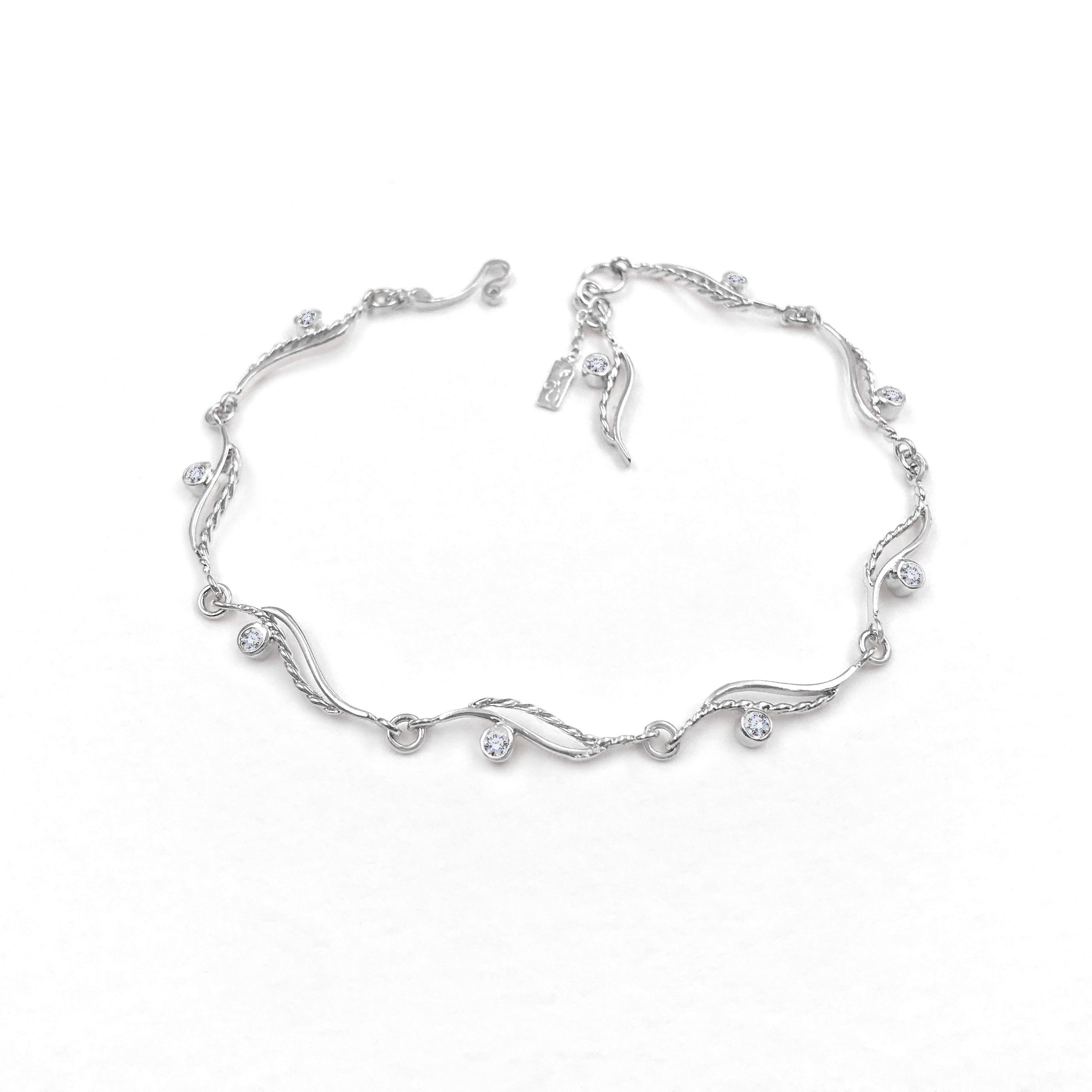 River-Rose twist wave flow bracelet featuring 8 wavy links and a matching dangle and logo tag. Each link is defined with a bezel set 2mm diamond.  JeweLyrie signature infinity twist is forged into flowing wave, double up with high polished square
