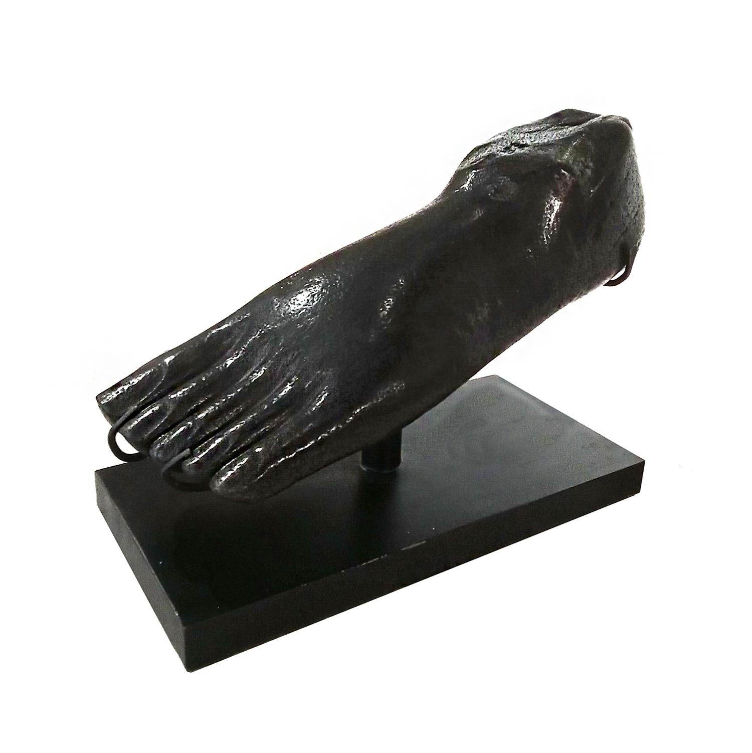 A foot sculpture from Indonesia, hand carved in solid river rock and polished. Original black color. Mounted on a black metal stand. Dimensions: 15 inches wide, 6.5 inches deep, 10.5 inches high.
Can be used outdoors as a garden element or patio