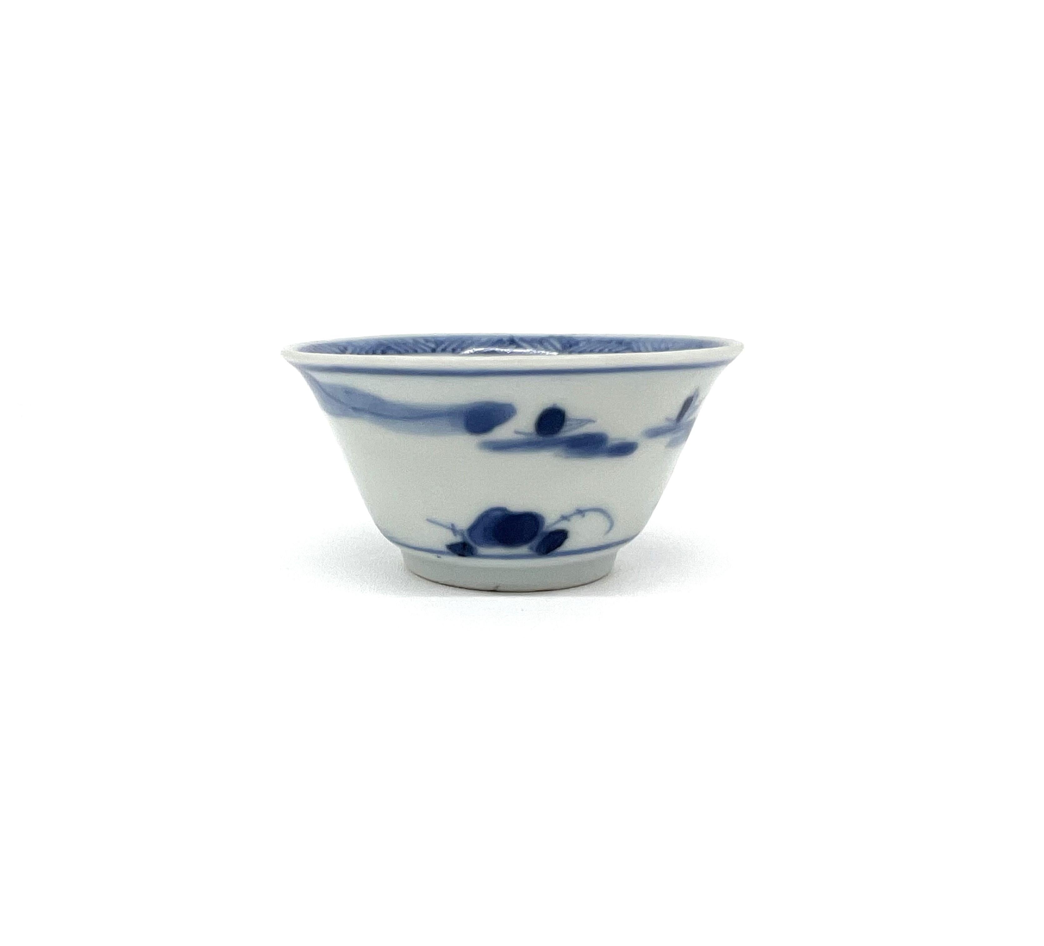 The serene landscape and leisure activity of fishing are meticulously captured in cobalt blue on the porcelain's white surface, suggesting the value placed on harmony with the natural world. The bowl's shape is traditional, with a broad rim and deep