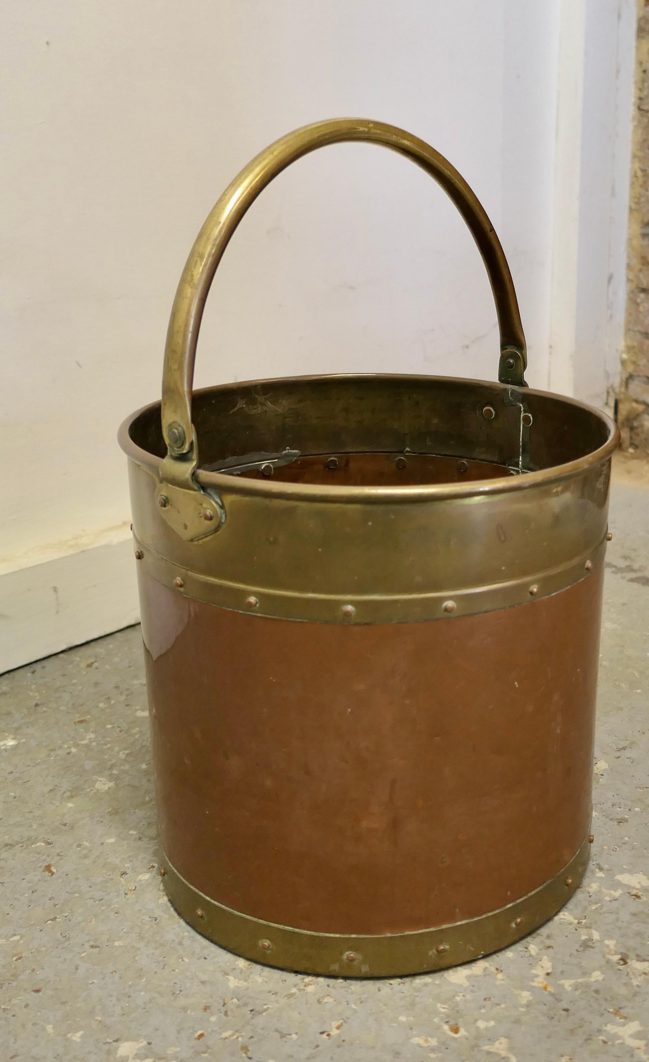 Riveted copper and brass coal bucket.

This is a lovely strong copper coal bucket, this is a good big piece and would make a really good coal or log container and handy because it has a riveted brass carrying handle.

The bucket is in good well