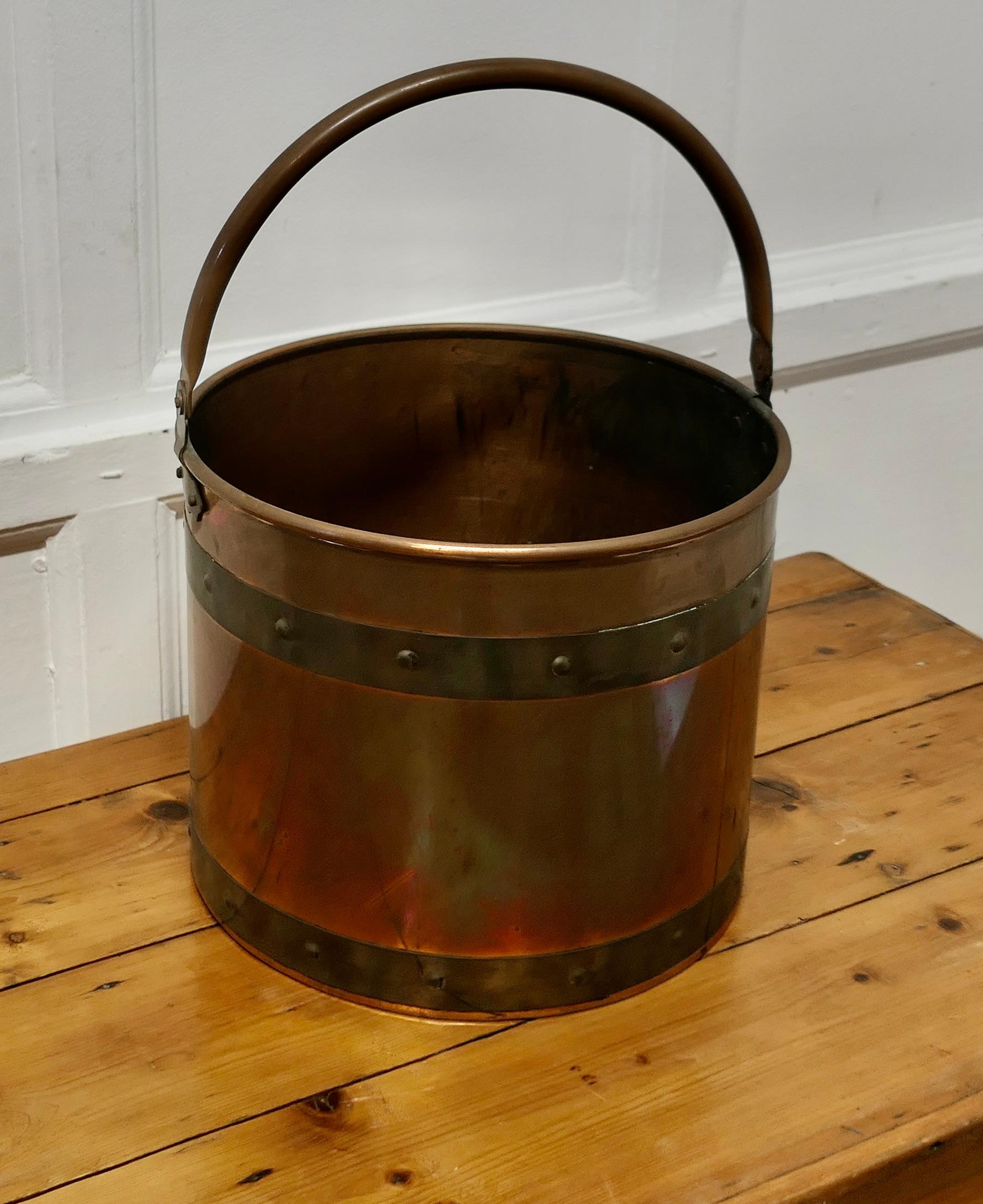 Riveted Copper and Brass Coal Bucket 

This is a lovely strong copper coal bucket, this is a good big piece and would make a really good coal or log container and handy because it has a riveted brass carrying handle

The bucket is in good well aged