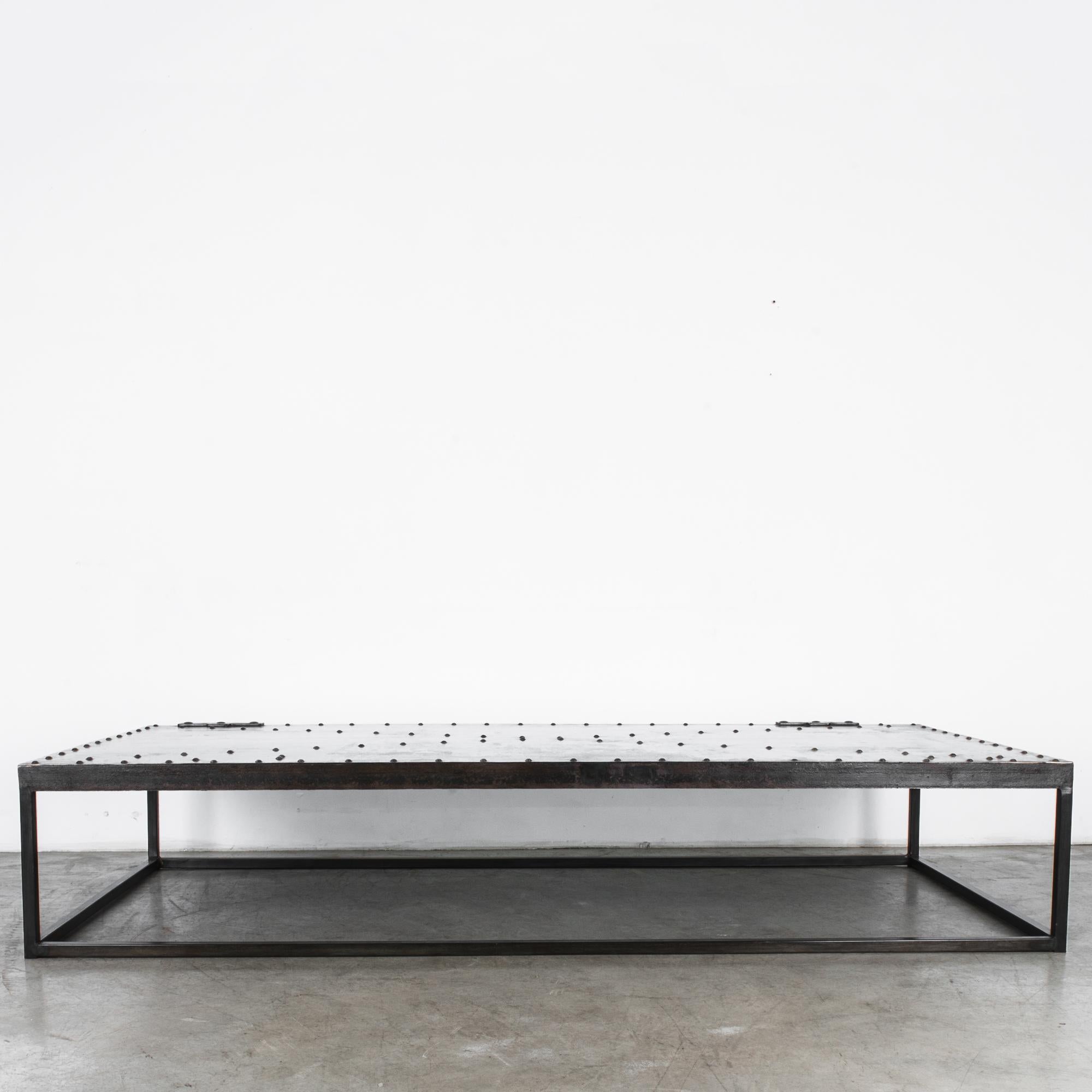 A reclaimed iron door from Central Europe circa 1900, transformed in our atelier into a stylish coffee table. Fixed to a minimal steel base, an intriguing architectural element becomes a stylish coffee table. Polished to a satin shine, this iron
