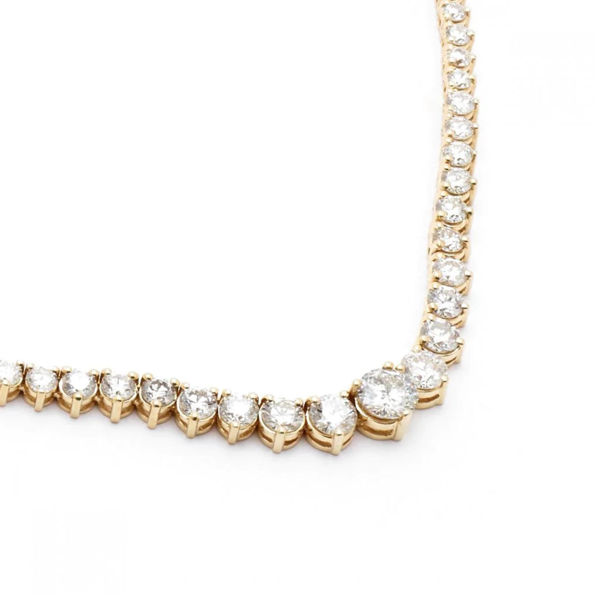 stunning 17.5-inch Graduating Tennis Necklace, a true embodiment of luxury, meticulously crafted in lustrous 18K Yellow Gold. This exquisite necklace is adorned with 168 round diamonds, each securely nestled in a three-prong setting, showcasing a
