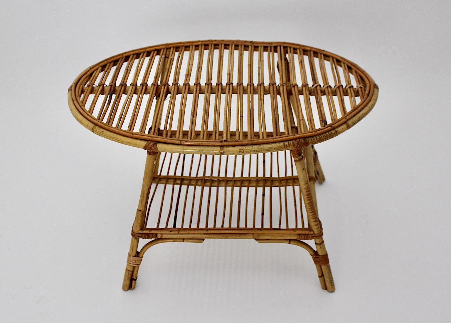 Riviera Style organic vintage patio coffee table or side table from rattan with two tiers oval like 1950s Italy.
A stunning Mid-Century Modern oval like coffee table or side table from amazing
rattan network with two tiers.
This livable coffee