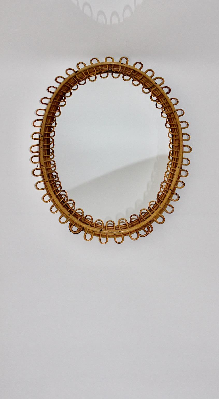 French Riviera Style Vintage Rattan Organic Oval Sunburst Wall Mirror 1950s France For Sale