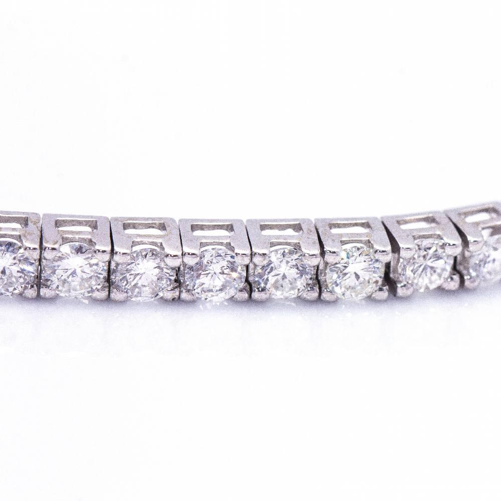 Women's Diamond and White Gold Bracelet : 50x Brilliant Cut Diamonds with a total weight of 4.96ct. in G/VS quality, (individual stones of approx. 0.10ct. each) : 18 kt. White Gold : 13.90 grams : Solid : 18 cm long : Drawer clasp with 2x safety