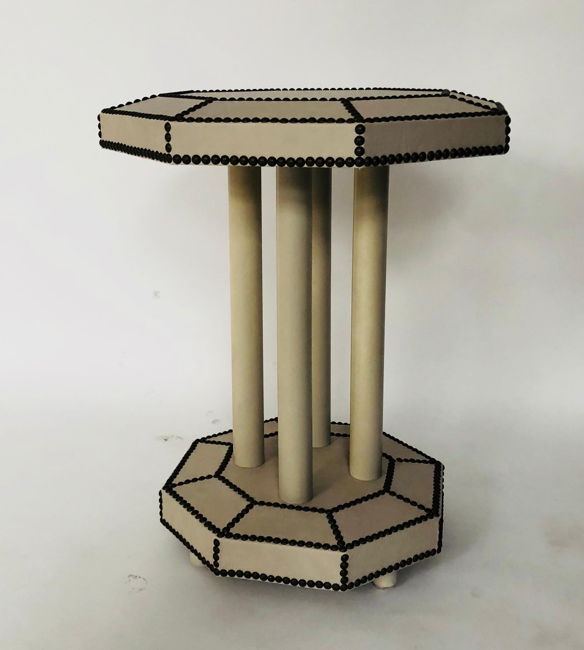 Leather tops give these octagonal side tables their sophisticated style. The nailheads define and highlight the bevelled edges on both the top and bottom surfaces. The tables are perfect size for end tables, yet are customizable with numerous